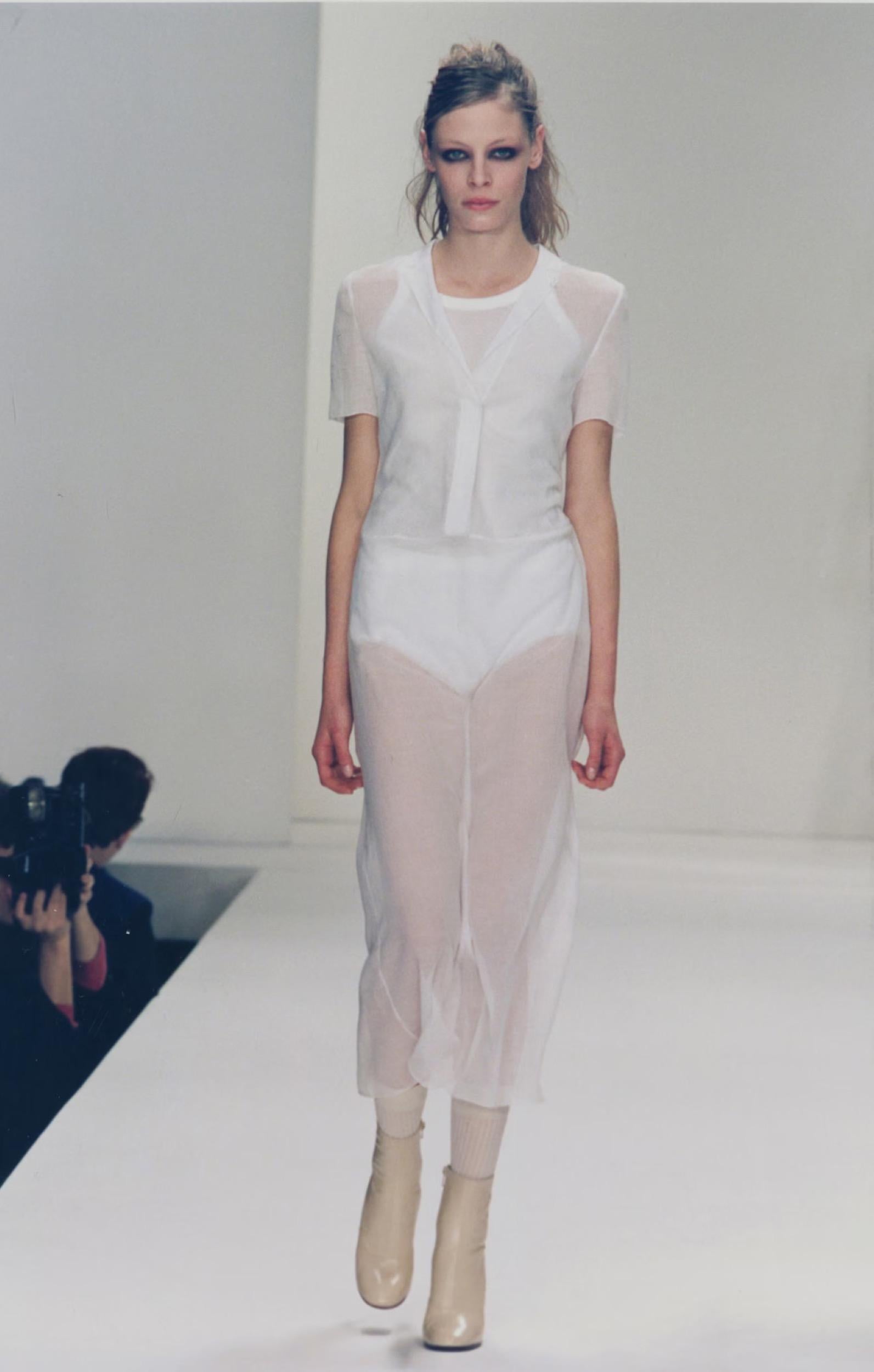 Spring/Summer 1997 Miu Miu Cotton Day Shirt Dress
FR 42
Sheer Black
Crisp cotton with impeccable, delicated finishing
Elongated Placket of Lingerie Inspired Hook and Eye Closures at Front
Slips on
Small Crisp Collar
V-neck
Shown on runway in white