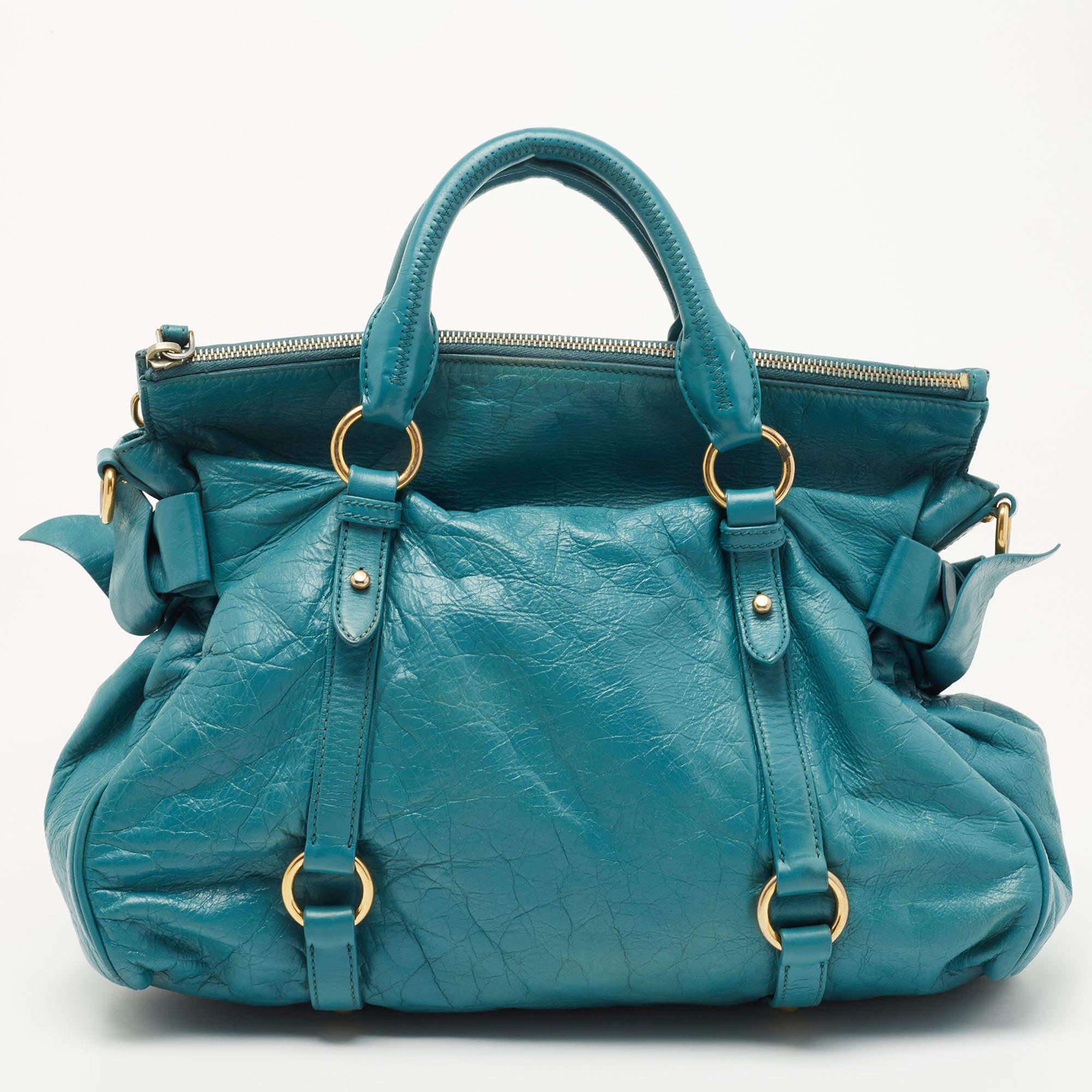 Simple in shape and design, this bag by Miu Miu will be a loved addition to your closet. It has been crafted from Vitello leather and styled minimally with gold-tone hardware. It comes with two top handles and a fabric-lined interior.

Includes: