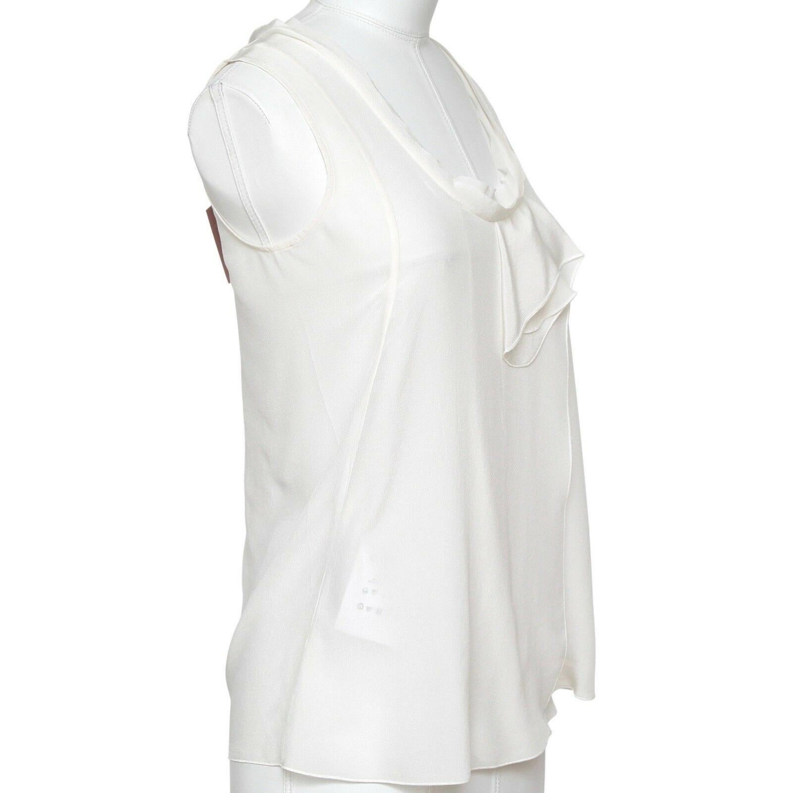 GUARANTEED AUTHENTIC MIU MIU IVORY SLEEVELESS SILK BLOUSE


Design:
- Classic sleeveless silk top in an ivory color (latte).
- Ruffle trim town front.
- Looks great w/jeans or under a jacket.
- Slip on.
- Unlined. 
Size: 36

Material: 100% Silk