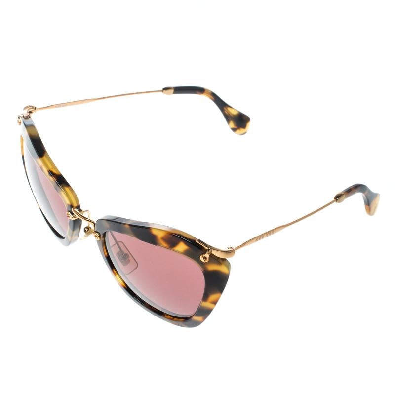 Beat the summer with these cool shades by Miu Miu. These cat eye sunnies feature gold-tone metallic bridge, pad arms, and temples with brand details. Metal hinges stylishly rest on the top of the tortoise acetate rims, which encase pink-shaded