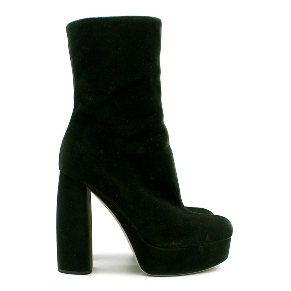 Green velvet and leather platform ankle boots from Miu Miu. Fastened with a leather-trimmed side zip. 

- Outer: Velvet 100%
- Sole: Leather 100%, Rubber 100%
- Lining: Calf Leather 100%

Heel height 12,5 cm
Platform 3 cm
Shaft height 21 cm

