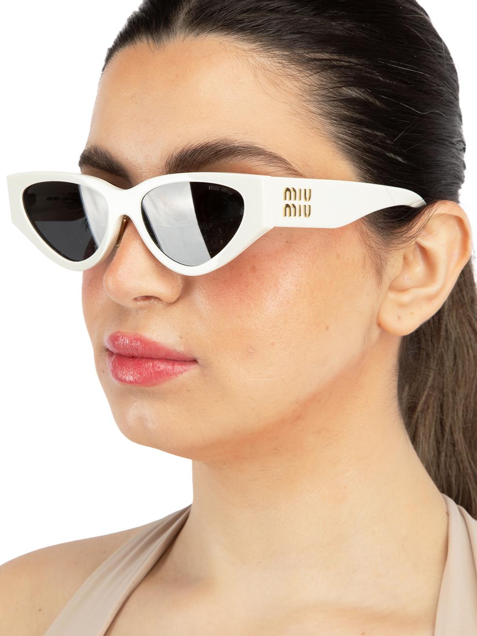 CONDITION is New with tags on this brand new Miu Miudesigner item. This item comes with original packaging.
  
  Details
  Model: MU 03ZS
  White
  Acetate
  Cat Eye Sunglasses
  Gold Hardware
  Tinted Dark Grey Lens
  Branding at the arms
 