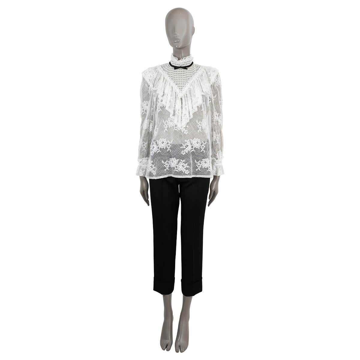 100% authentic Miu Miu semi sheer blouse in white floral lace cotton (assumingly - content tag is missing). Features a mock neck with black mini bow tie, ruffles and bell sleeves. Closes with buttons on the neck. Has been worn and is in excellent