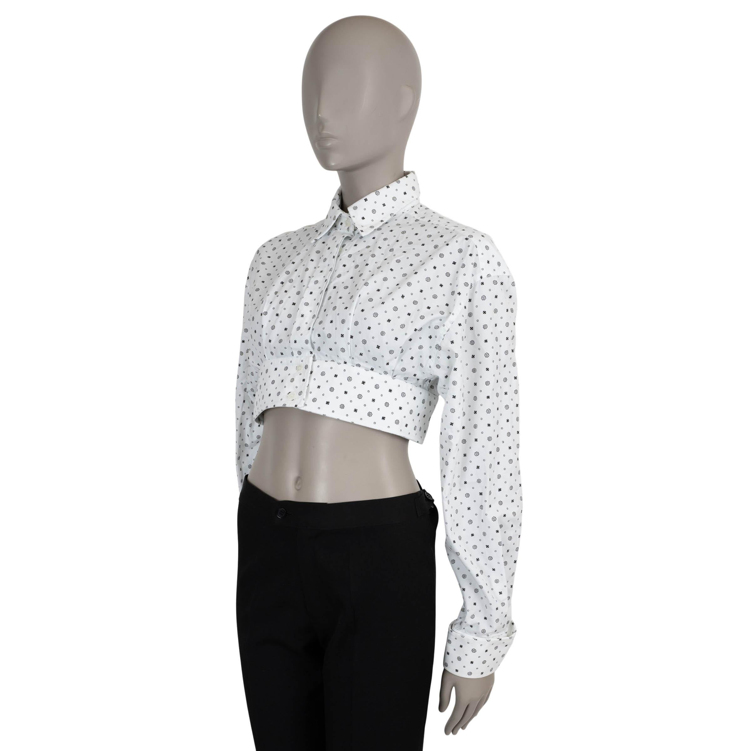 This 100% authentic Miu Miu floral cropped button-up shirt is crafted from crisp white cotton and features a bold black floral print for a striking contrast. Designed with drop shoulders for a relaxed, modern fit, the shirt is finished with