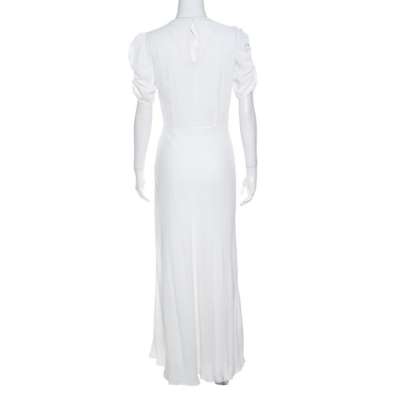 This wonderful dress from Miu Miu is classic and timeless. The pristine white creation is made of a viscose blend and features a floral design that is embellished with crystals and beads. It flaunts a V-neckline, short ruched detailed sleeves and a
