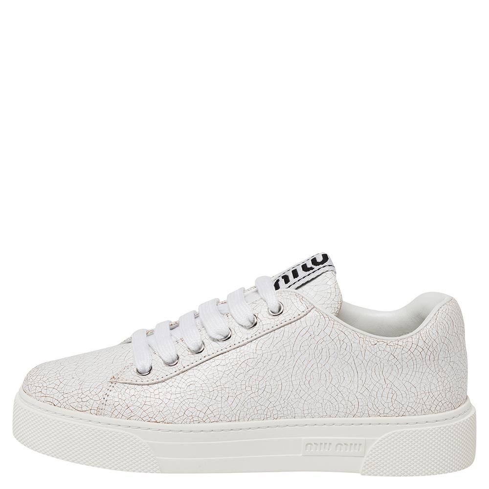 A pair of sneakers by Miu Miu to take you places in style and comfort. The white sneakers have been crafted from leather and styled with lace-ups, simple round toes, and the logo on the tongues and soles.

Includes: Original Box, Info Bookle