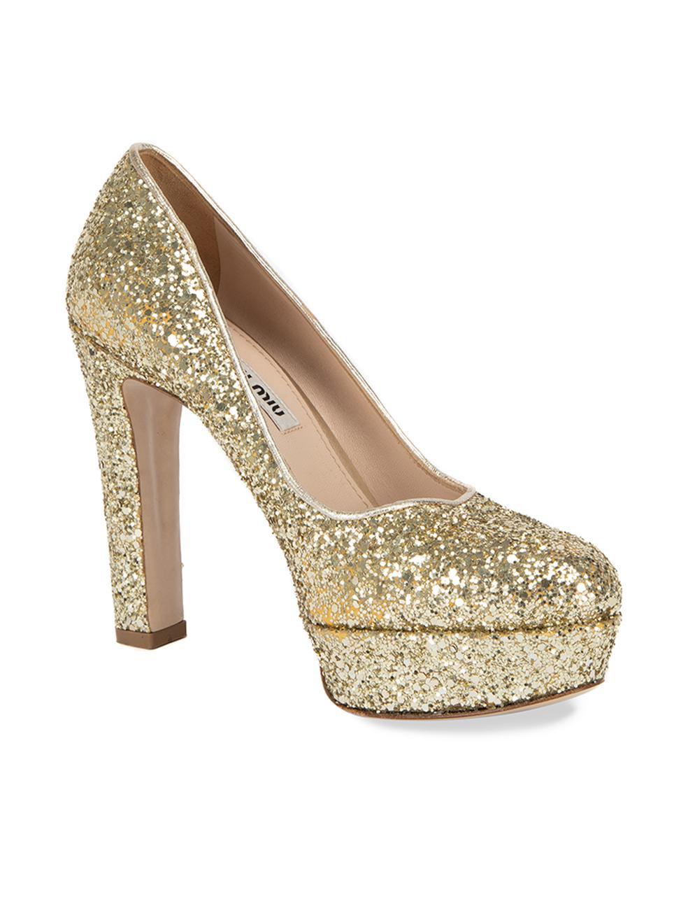 CONDITION is Very good. Minimal wear to shoes is evident. Some glitter has fallen off which is most evident around the inside of the left shoe on this used Miu Miu designer resale item.   Details  Gold Glitter Slip on heels Almond toe Platform high