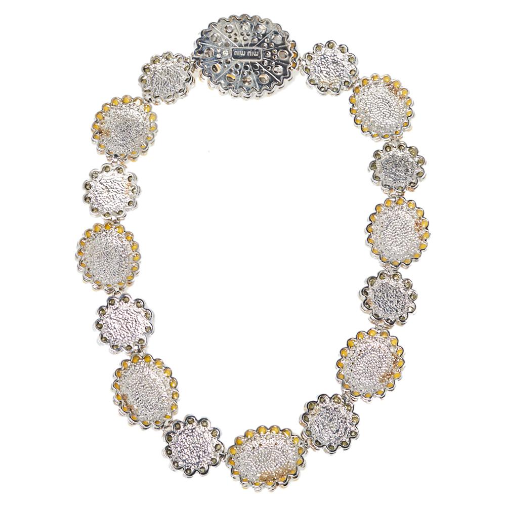 The choker necklace trend is topping the charts this season and to match that here’s our pick from Miu Miu. A statement piece, this silver-tone choker has a breathtaking arrangement of flower motifs embellished with yellow resin and crystals. Wear