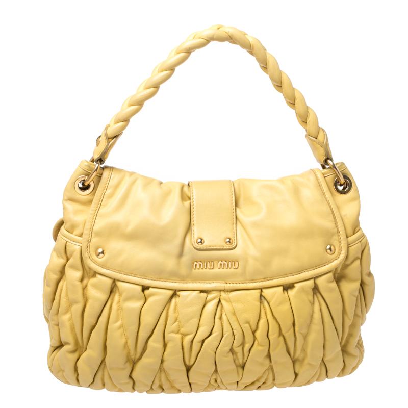 This chic and feminine Coffer hobo is from Miu Miu. The bag is crafted from Matelasse leather and features a flap that opens up to a satin-lined interior sized to fit your daily essentials. The hobo is equipped with a braided top handle and a