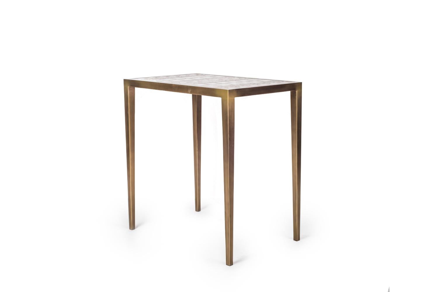 The mix media nesting side table in medium is part of a series of nesting side tables (sold separately). One can purchase the tables on their own or buy them as a set to create elegant and geometric shapes. This piece demonstrates the incredible