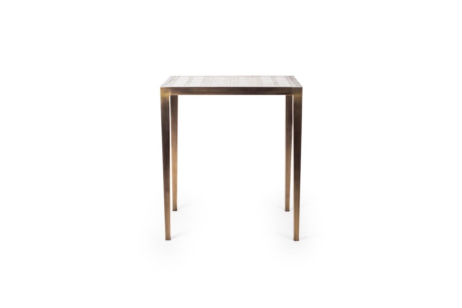 The mix media nesting side table in small is part of a series of nesting side tables (sold separately). One can purchase the tables on their own or buy them as a set to create elegant and geometric shapes. This piece demonstrates the incredible