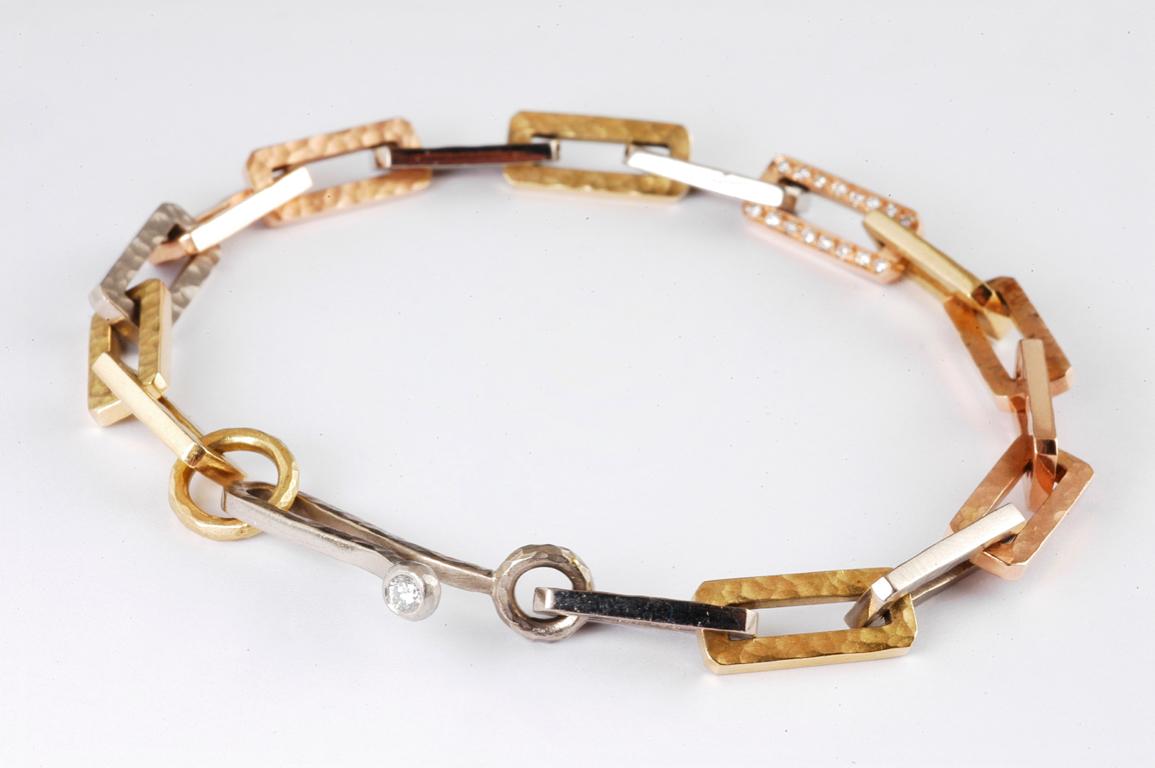 18ct yellow, white, and rose gold rectangular link bracelet with channel set brilliant cut diamond link 0.20cts total weight. Hand made in London by renowned British jeweller Malcolm Betts.
This piece can be made also in platinum, without the