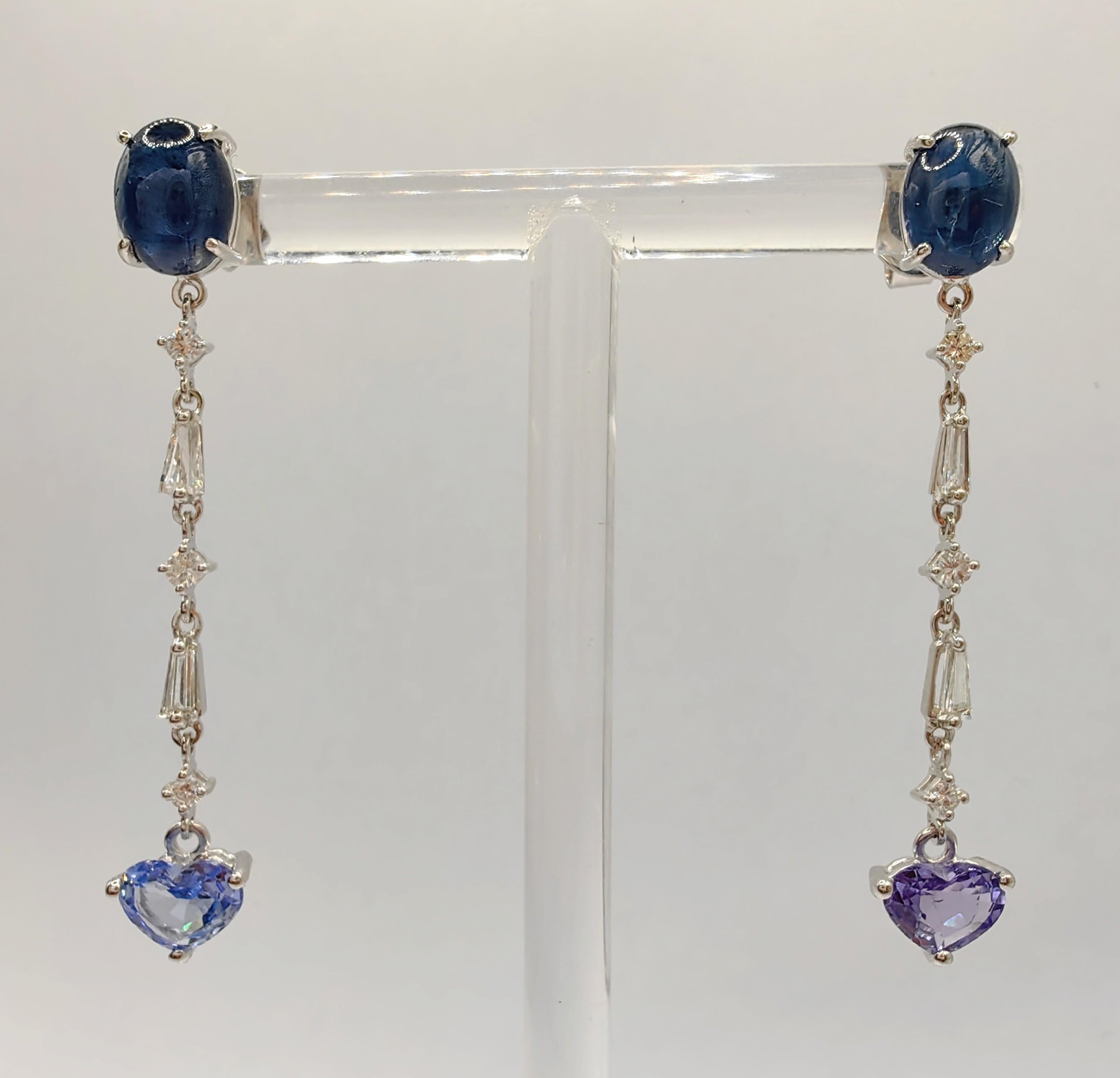 Introducing our Cabochon & Heart Cut Sapphire Diamond Dangling Earrings in 18K White Gold, a mesmerizing testament to elegance and individuality. These exquisite earrings are designed to grace your ears with sophistication, making a statement of