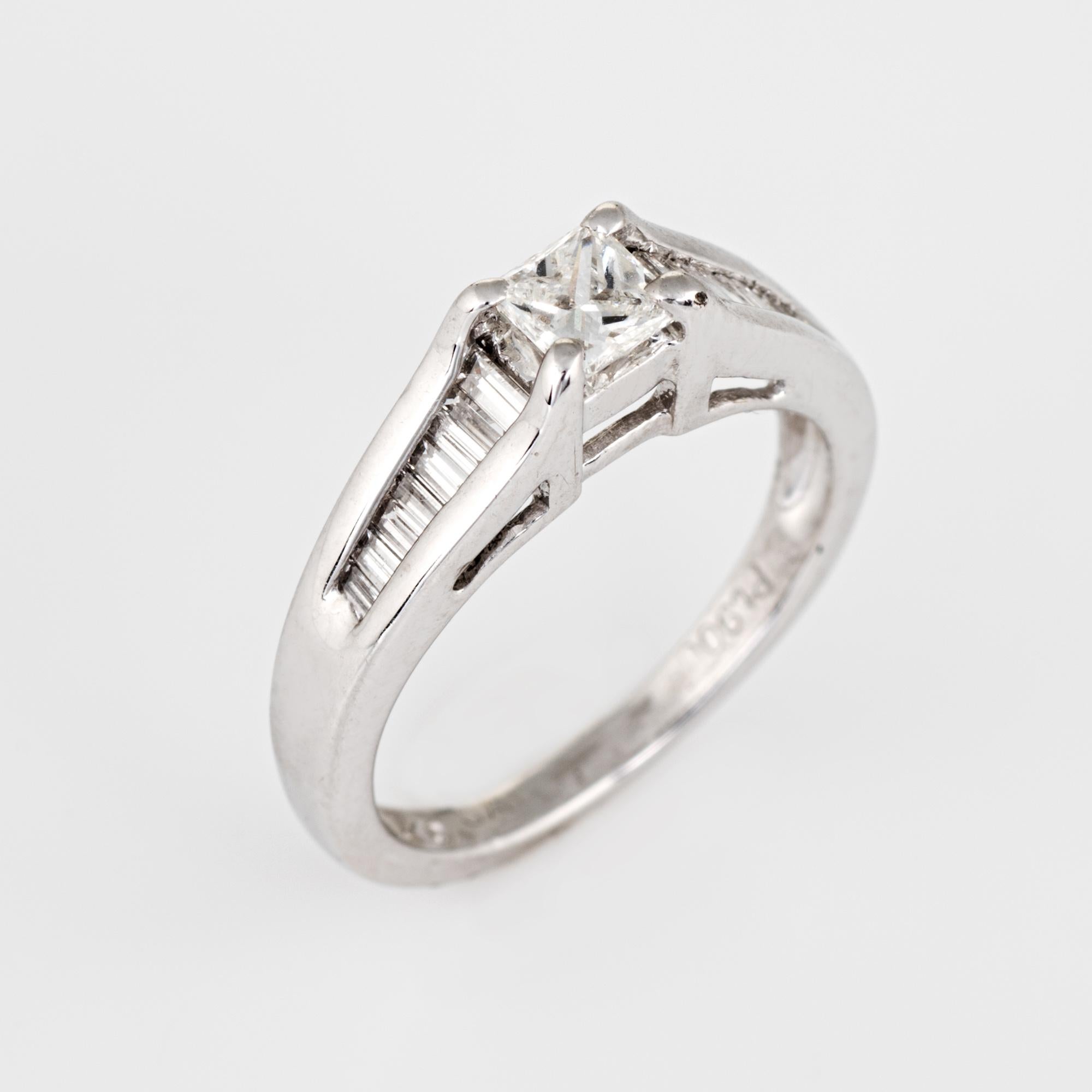 Finely detailed mixed cut diamond engagement ring crafted in 900 platinum. 

Centrally mounted estimated 0.25 carat princess cut diamond is accented with an estimated 0.48 carats of straight baguette cut diamonds. The total diamond weight is