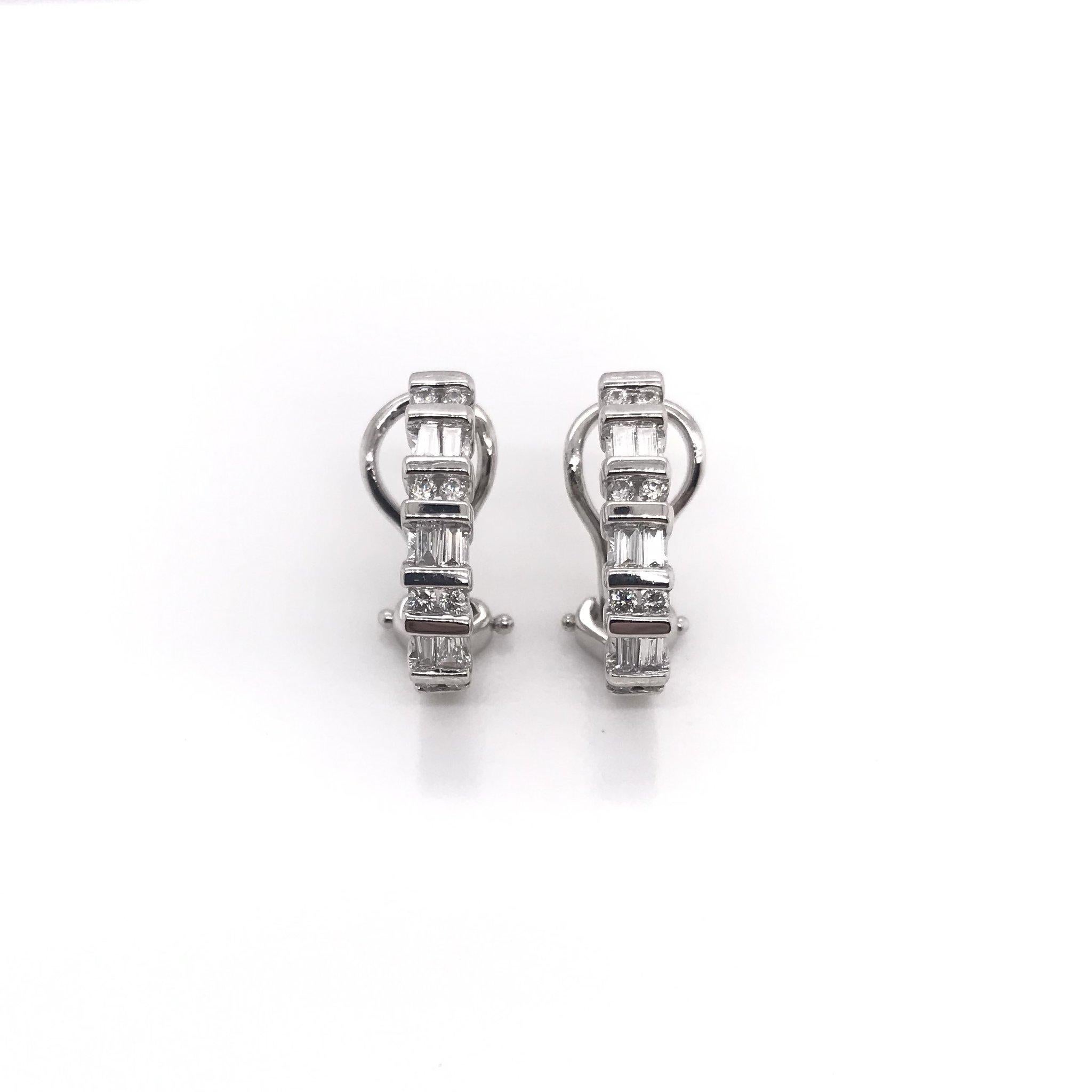 These diamond earrings are an estate piece. These 14k white gold hoop style earrings feature 8 round cut diamonds and 6 baguette cut diamonds each, for a total of 28 diamonds in the pair. The total combined diamond weight measures approximately 1