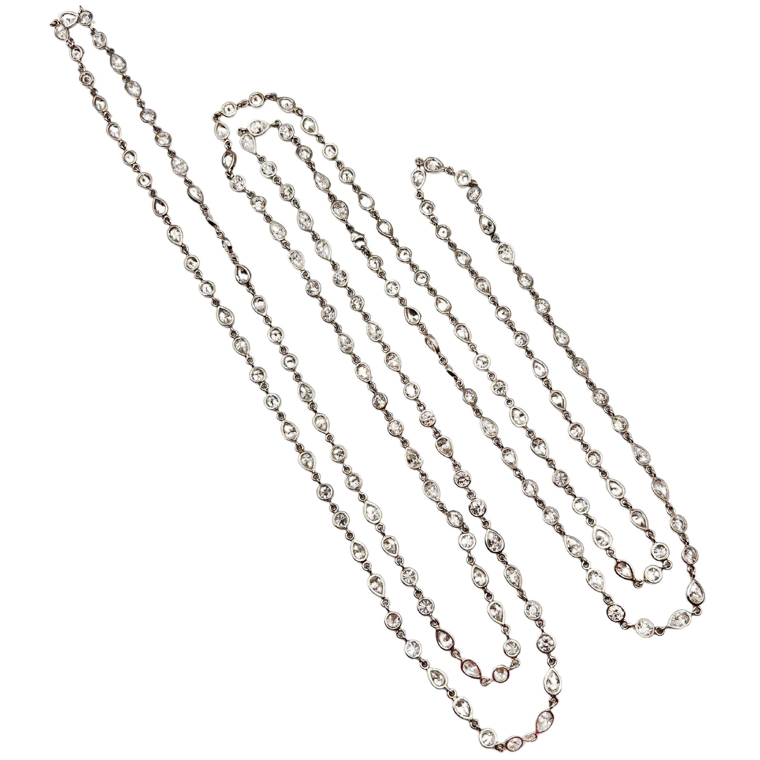 Diamonds-by-the-yard long chain necklace, featuring fine natural pear-shaped and round brilliant-cut diamonds.  The diamonds are all bezel-set in polished platinum.  82 pear brilliant-cut diamonds weighing approximately 26.10 total carats and 82