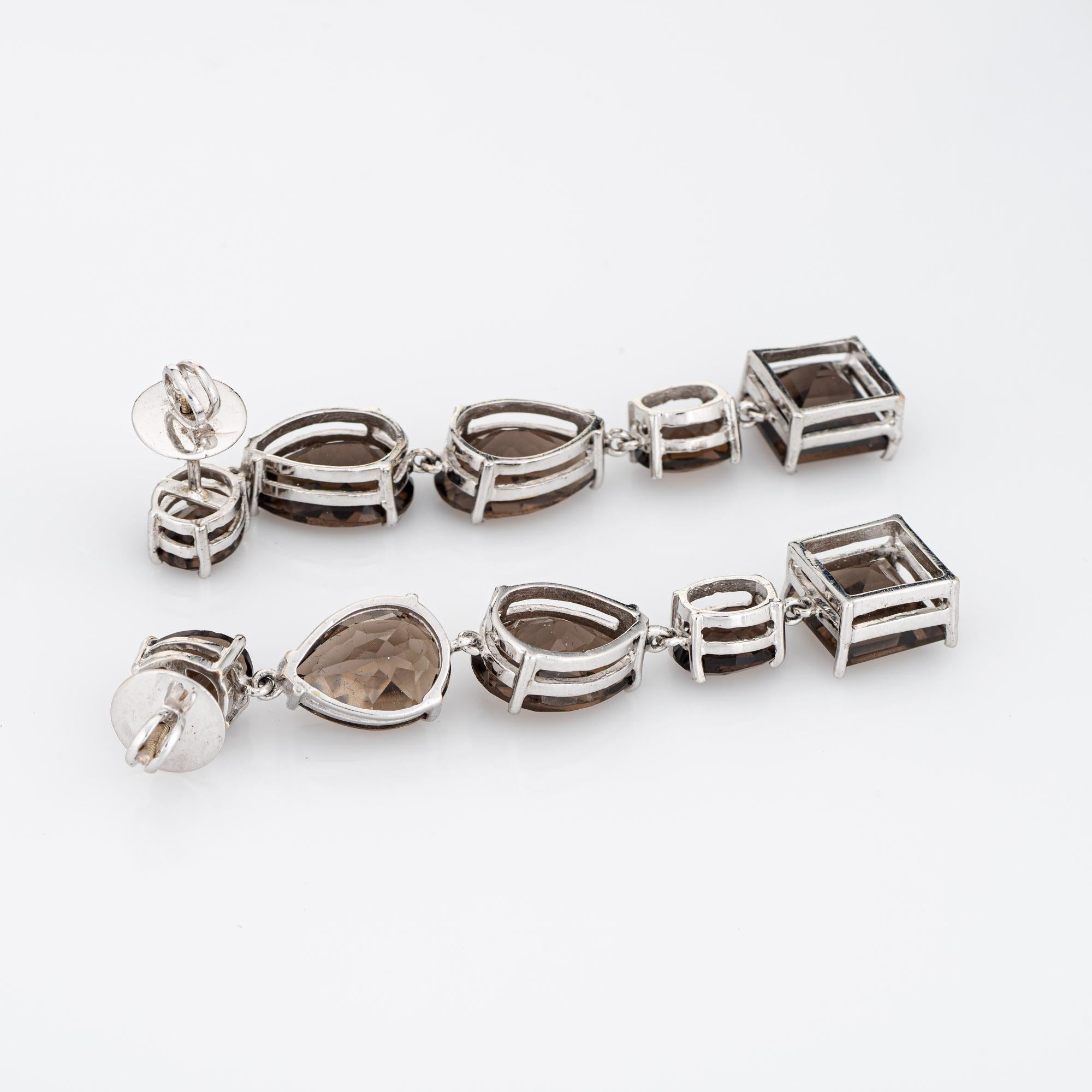 Finely detailed pair of estate mixed cut smoky topaz drop earrings crafted in 14k white gold. 

Smoky quartz in various shapes total an estimated 14 carats (in very good condition and free of cracks or chips).   

The earrings make a great statement