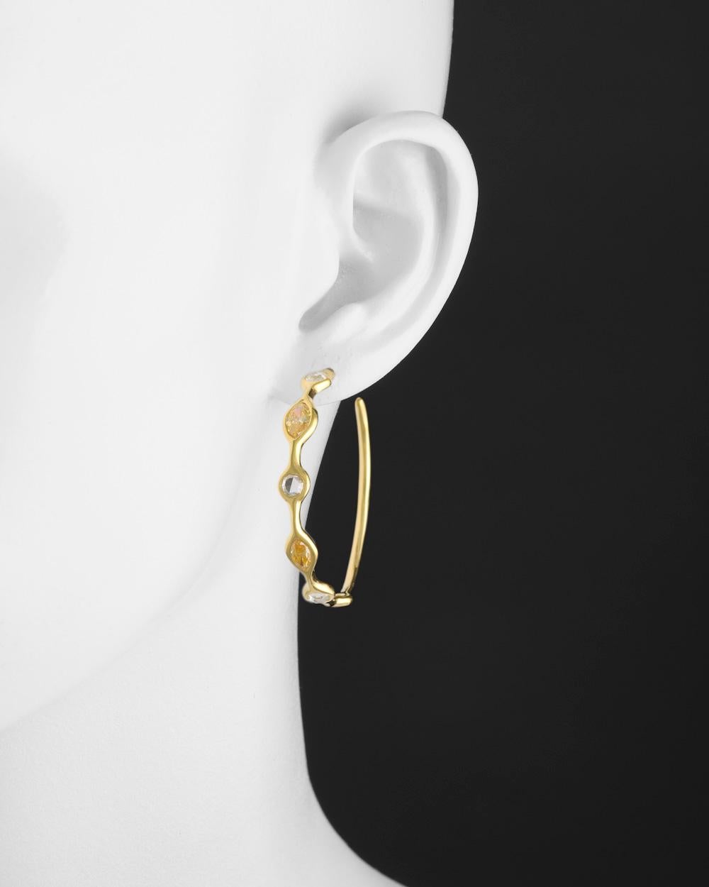 Large mixed-cut yellow and white diamond hoop earrings in handcrafted, free-form 18k yellow gold, set to the front with two marquise-shaped yellow diamonds, two round-cut yellow diamonds, and six round rose-cut near-colorless diamonds. The twelve