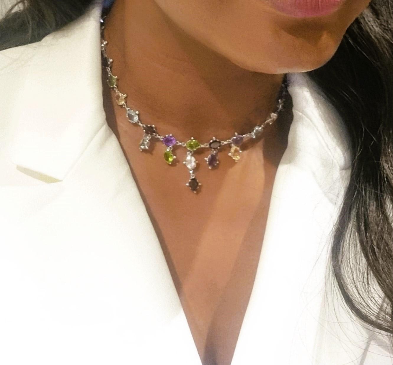 Introducing our extraordinary Mixed Gemstone Necklace, a true masterpiece of fine jewelry that showcases the enchanting beauty of five exquisite gemstones: Yellow Tourmaline, Peridot, Garnet, Topaz, and Amethyst. This necklace features a total of