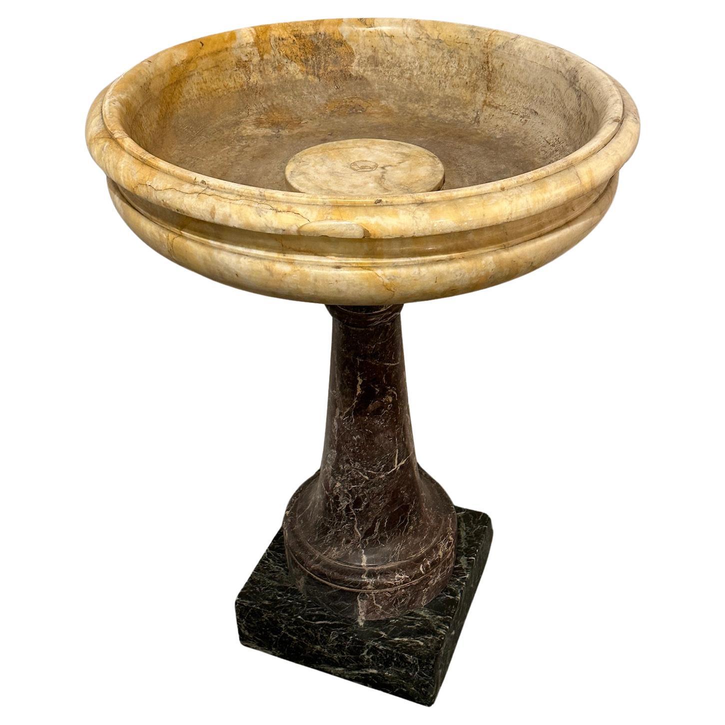 Large Baptismal font from Florence Italy with Sienna marble font and mixed marble base.  Formerly owned by the Romano Family, a prominent family of antique dealers to the popes and royal families. 