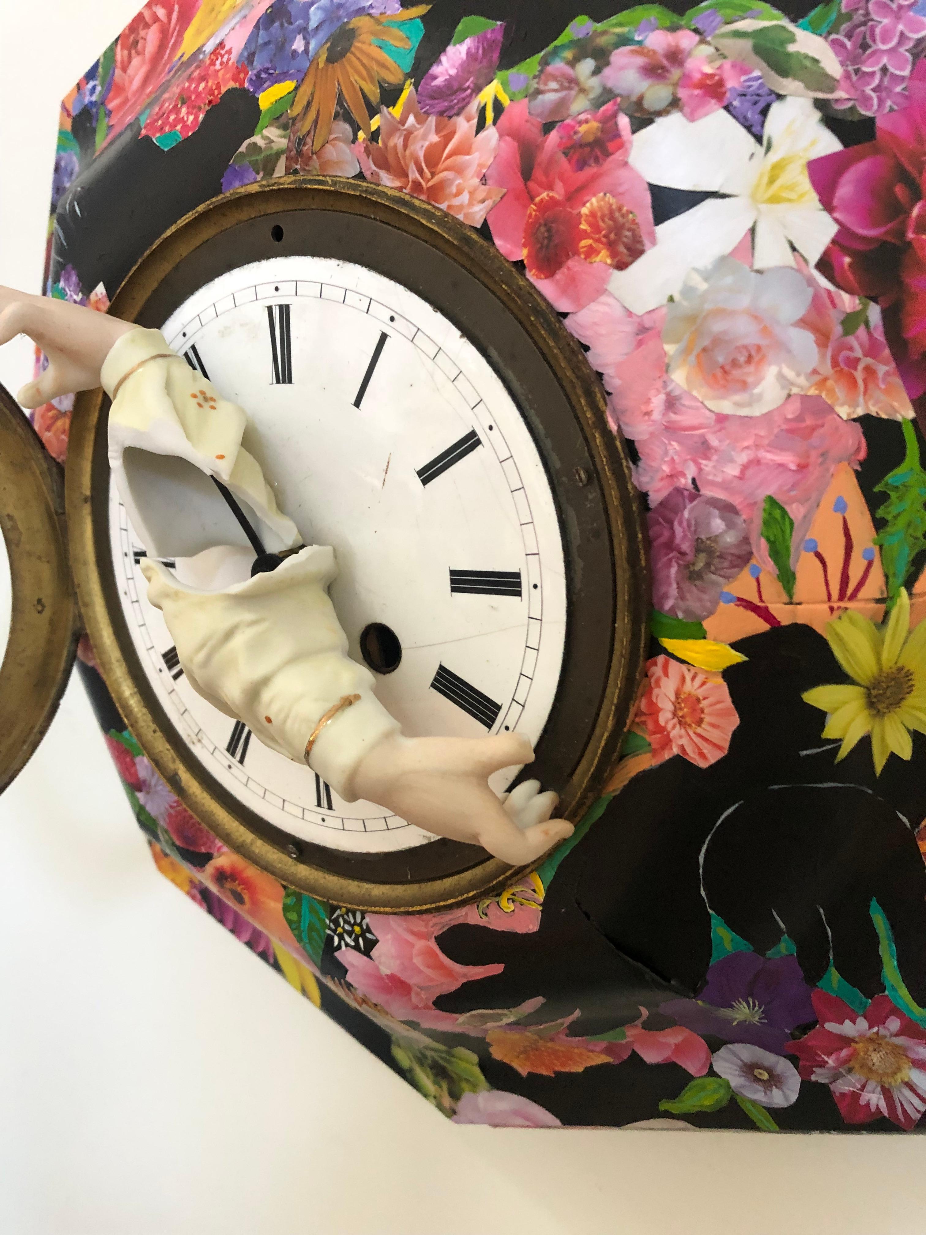 Eye catching and imaginative mixed media wall sculpture having a black antique clock that's collaged and painted with flowers and 4 unpainted areas in the shape of blackbirds that surround the white clock face. The hands on the face are actual