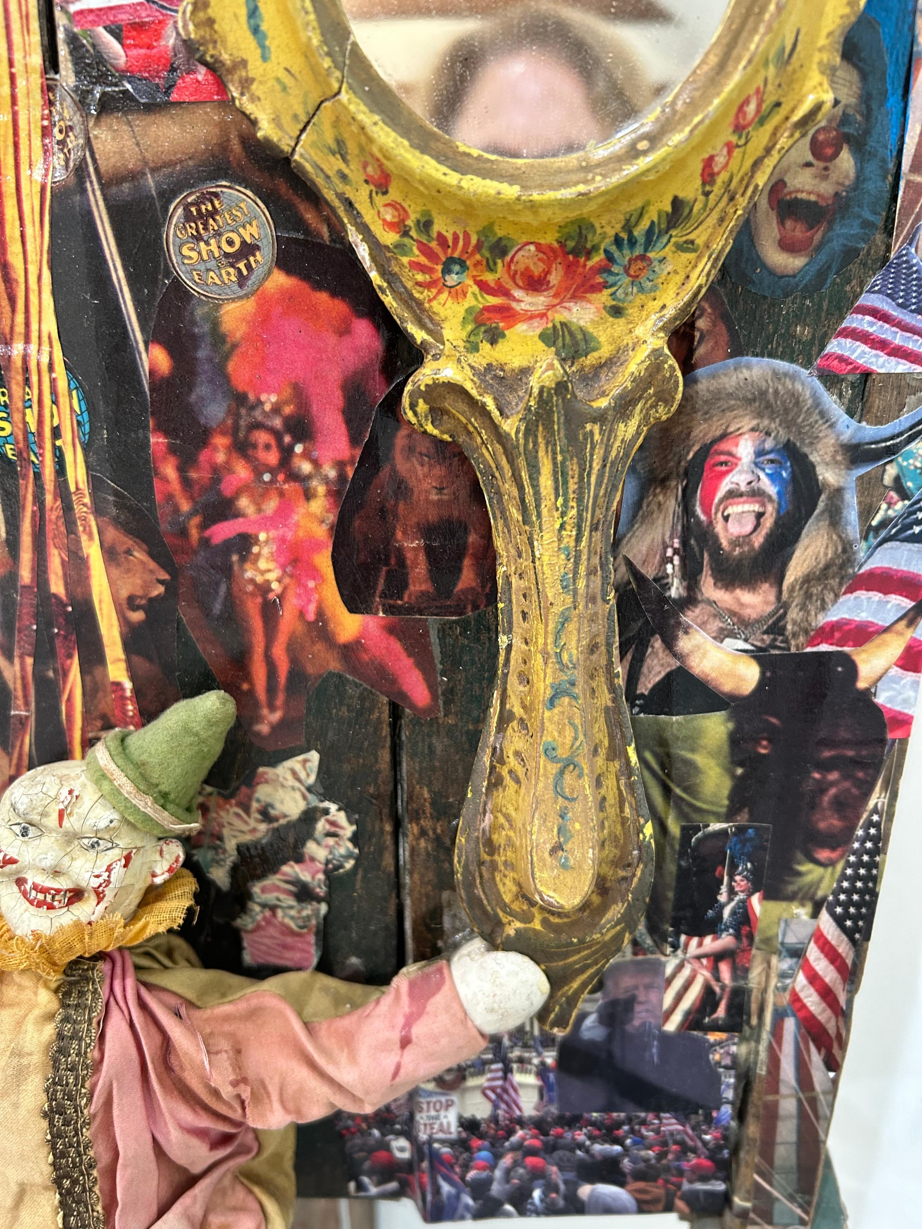 Eye catching thought provoking mixed media sculpture on distressed wheelbarrow  titled “ Circus World”.  The juxtaposition of circus imagery with frightening bits of news media text and photos of recent haunting events  are artist Fay Sciarra’s