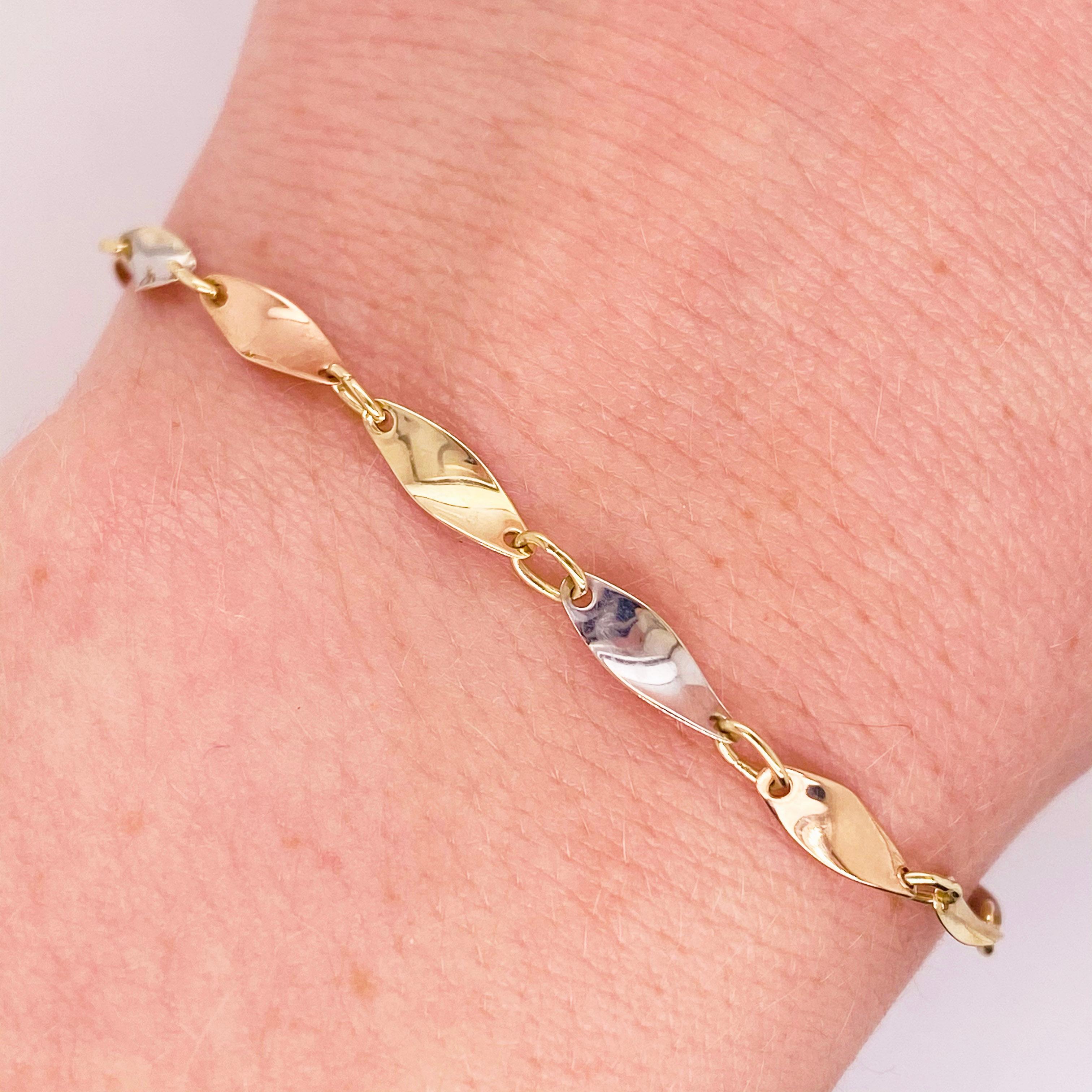 This is a handmade tri-color gold bracelet made with 3 gold colored links. The tri-color gold bracelet has a fun twisted design made with 14 karat rose, white and yellow gold. Each link was handmade and put together to create a beautiful fine
