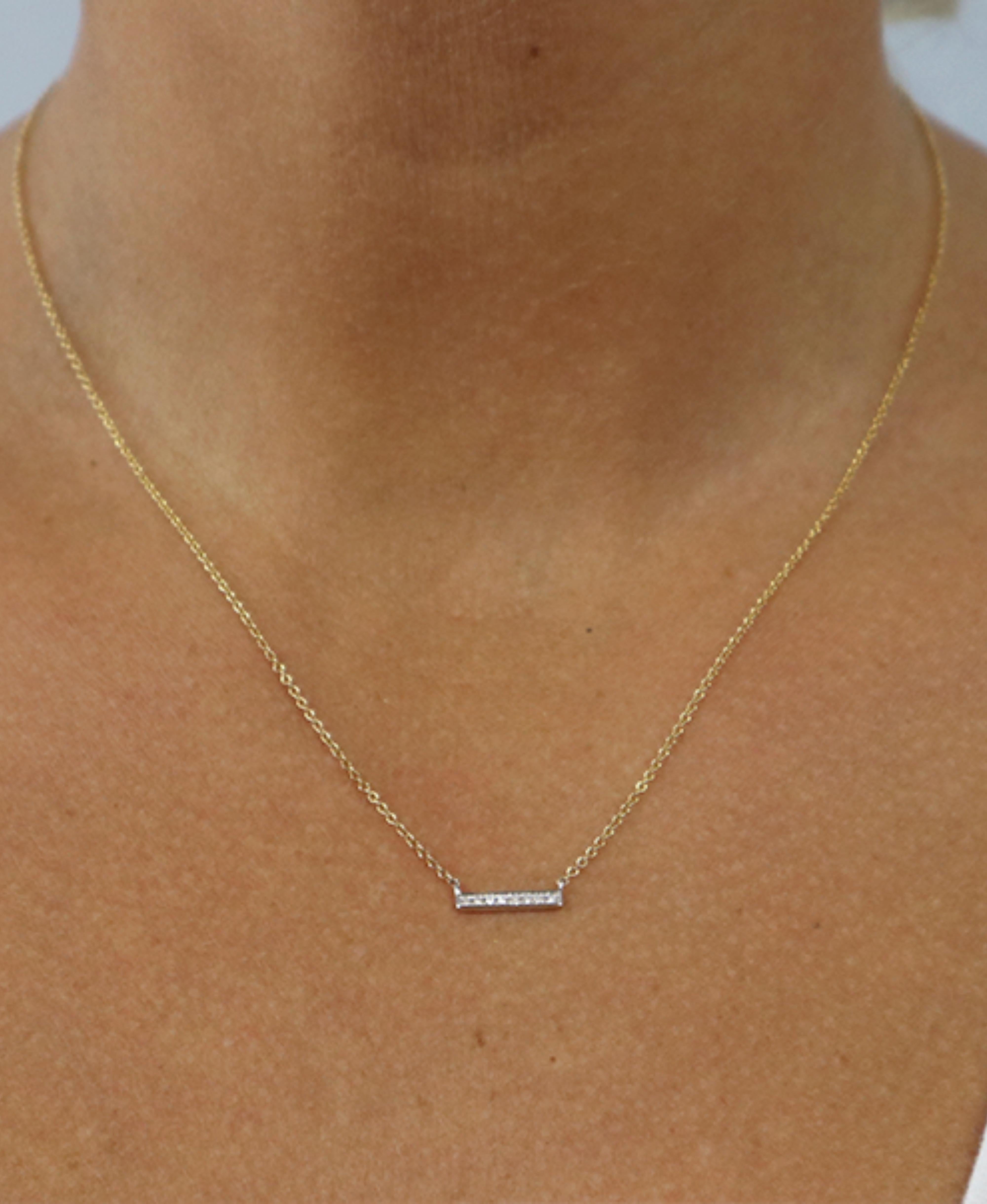 The Mixed-Metal Diamond Bar Necklace is a delicate and charming piece of jewelry that effortlessly marries the elegance of diamonds with the contemporary appeal of mixed metals. This necklace features a slender bar pendant, crafted with a