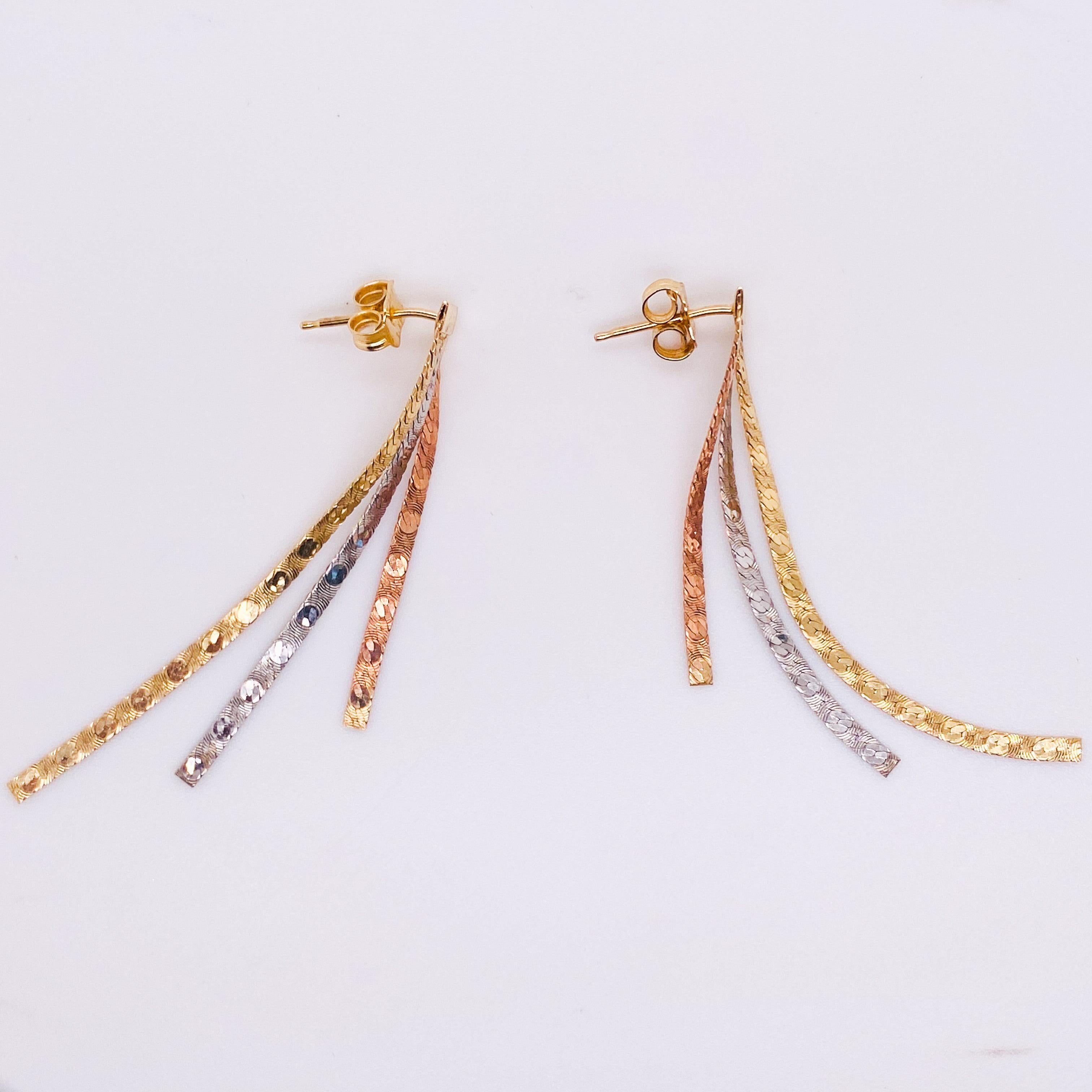 These clever mixed metal earrings look great for any occasion! The were made in Italy out of a combination of 14 karat yellow gold, white gold, and rose gold herringbone chain. The earring tops are a 14 karat yellow gold bar and post with friction