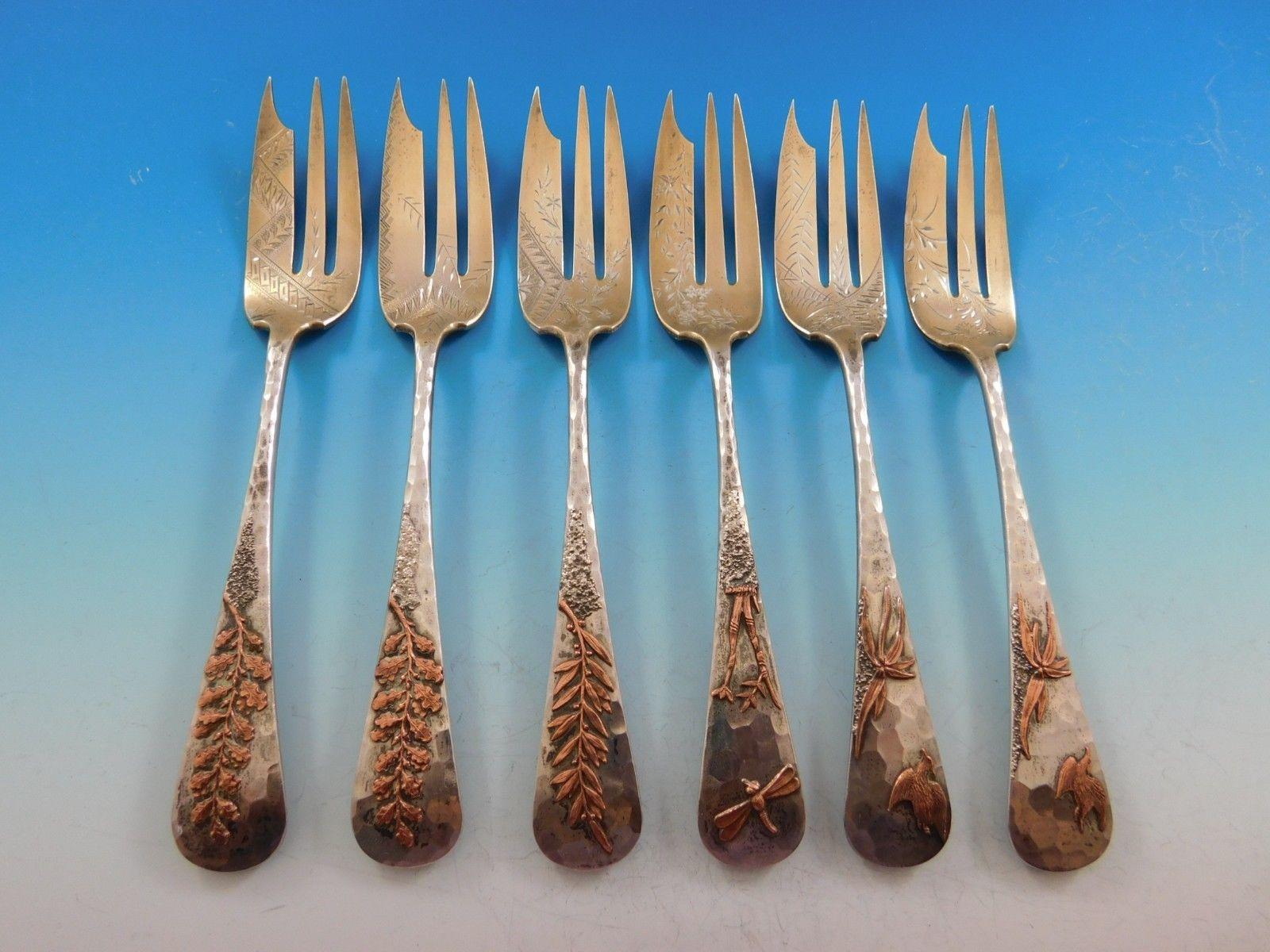 Mixed metals by Gorham

Set of six Gorham aesthetic mixed metals pie forks featuring applied Japanesque mixed metals elements. Bright cut geometric and foliate designs are found throughout the tines of the forks. The hand hammered handles feature