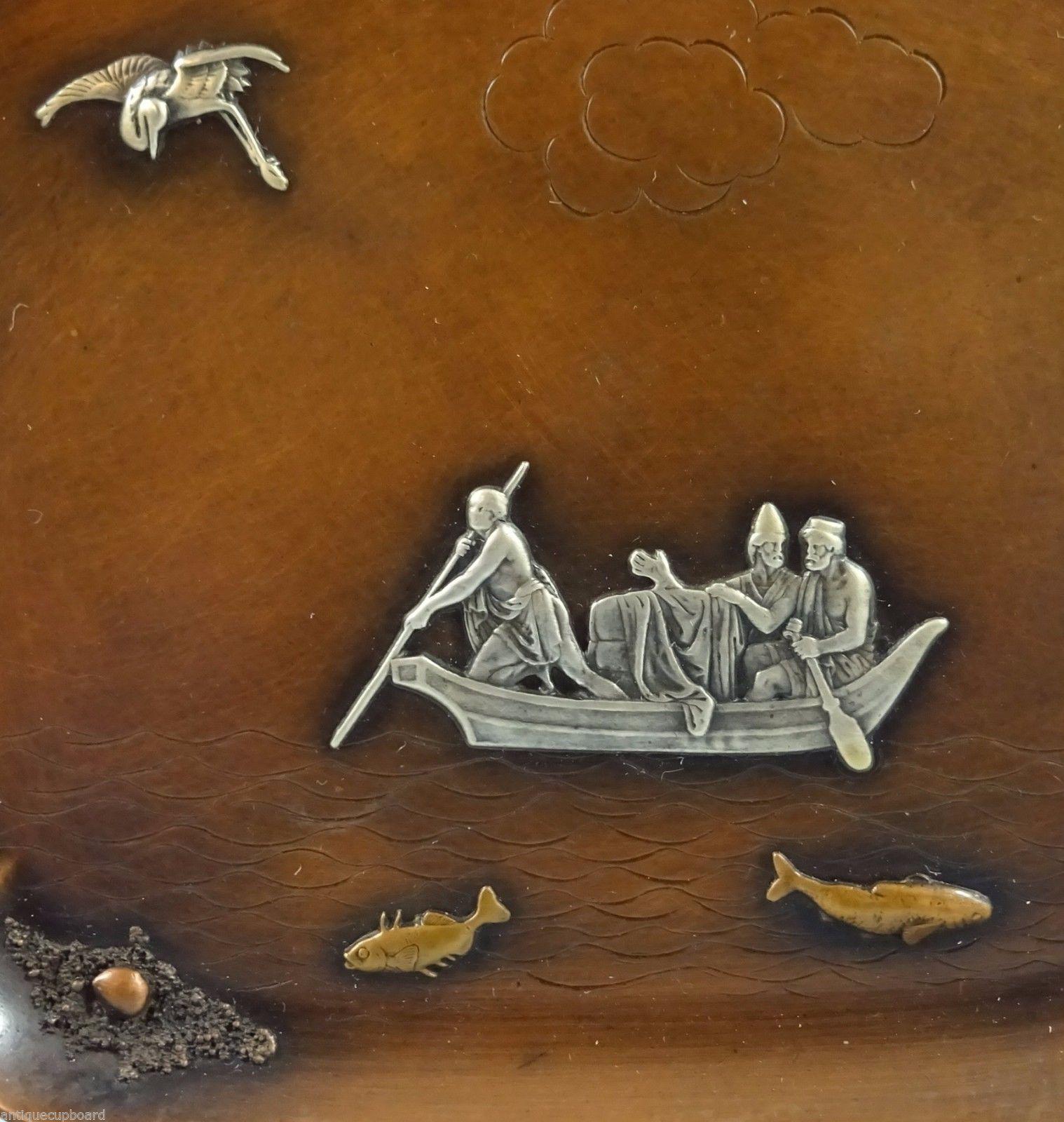 Mixed metals by Gorham

Fascinating mixed metals by Gorham tray made of copper. The piece has applied silver fishermen in boat, applied copper fish, and applied silver bird. It's marked with #B65. It measures 7 3/4 long, 6 1/8 wide and 1/2 tall,
