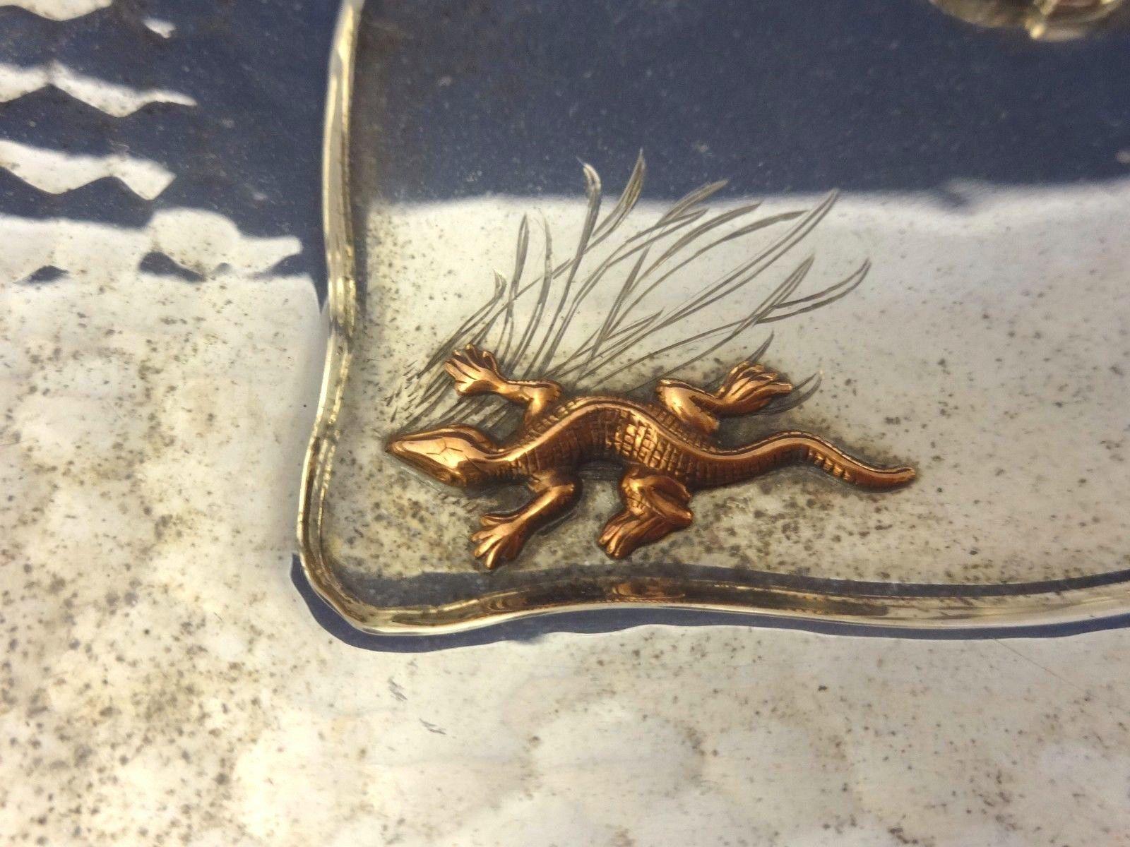 Mixed metals by Whiting Fabulous sterling square bowl made by Whiting. It has an applied gold bird over etched clouds and an applied copper lizard/salamander over etched grasses. The interior of the bowl has a hammered finish. It's marked with