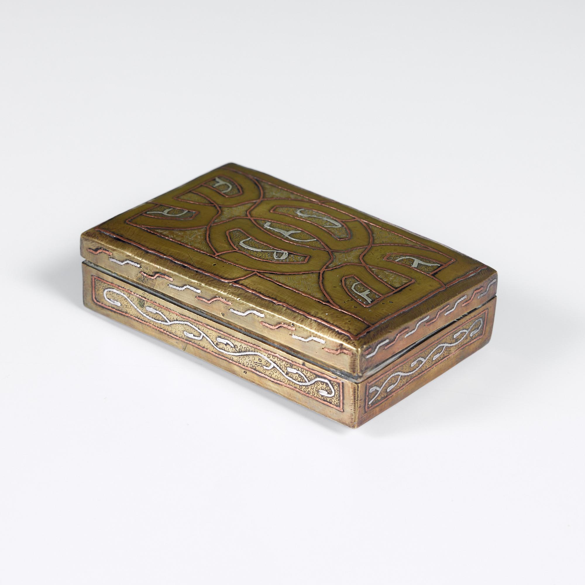 Rectangular bass, copper and silver cigarette box. The box features a hinged lid with a raised design of copper and silver on a brass box. The box is wood lined and ready to store your smoking paraphernalia. 

Dimensions
5.25