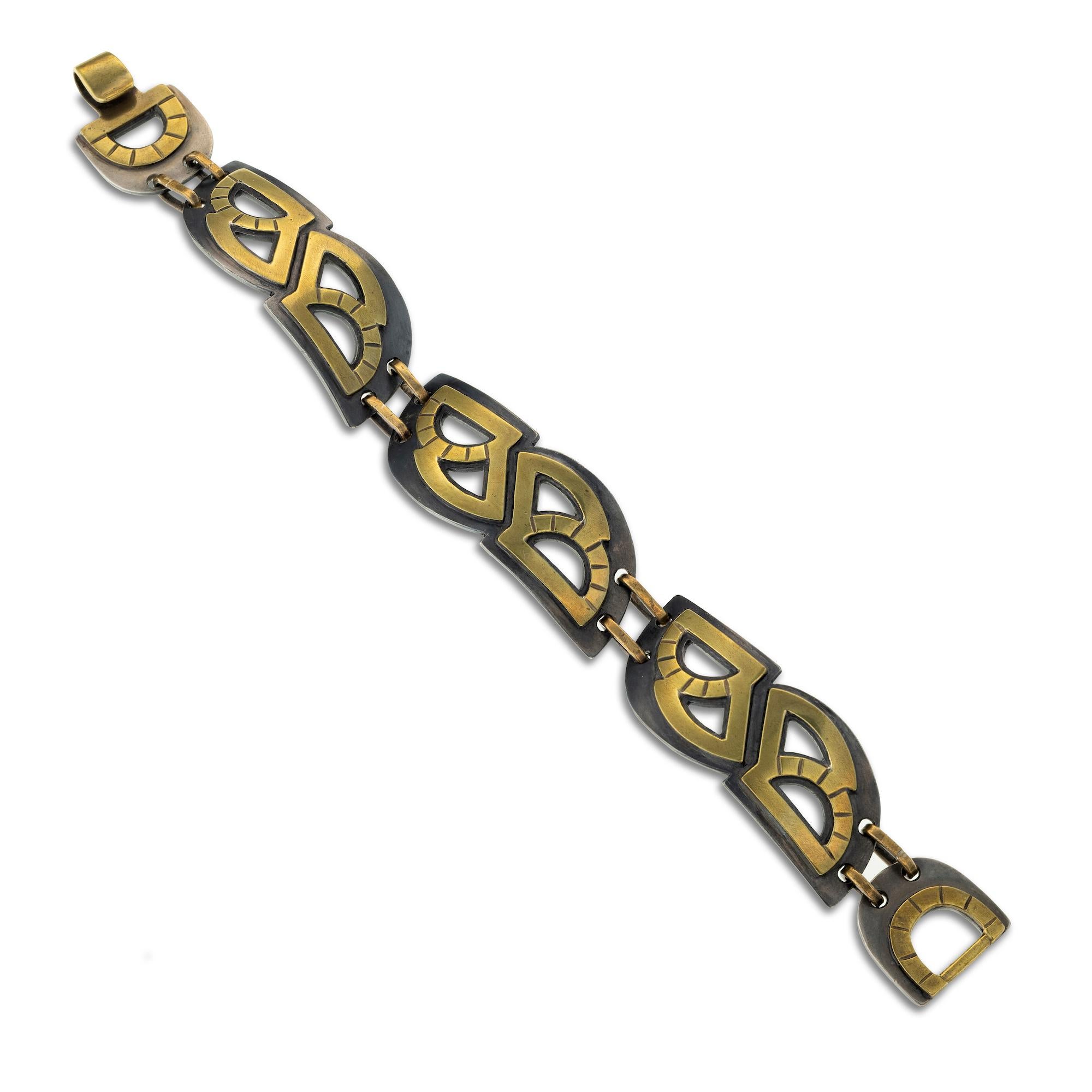 Oxidized sterling and brass make up the contrasting and rhythmic pattern of shapes in this sturdy and sophisticated link bracelet. 8.5