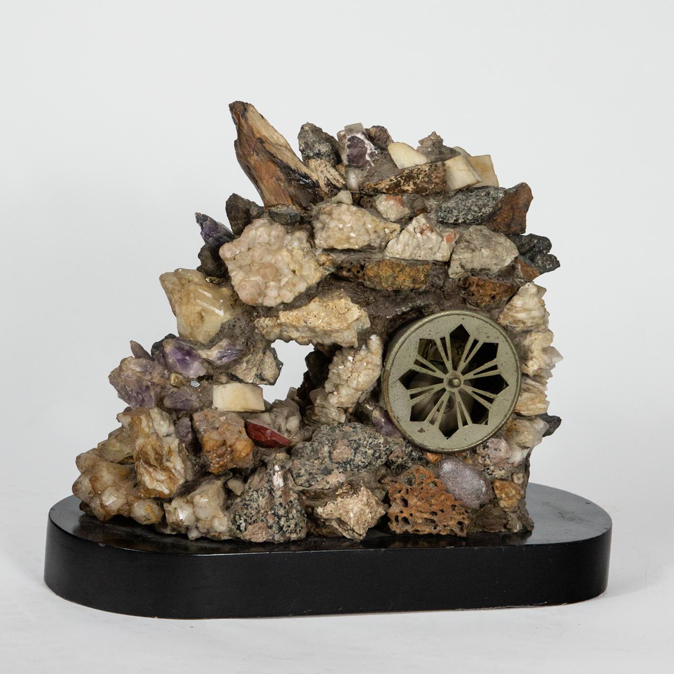 Mixed mineral clock with key. Roman numeral clock with key surrounded by minerals on black base. Measure: 15