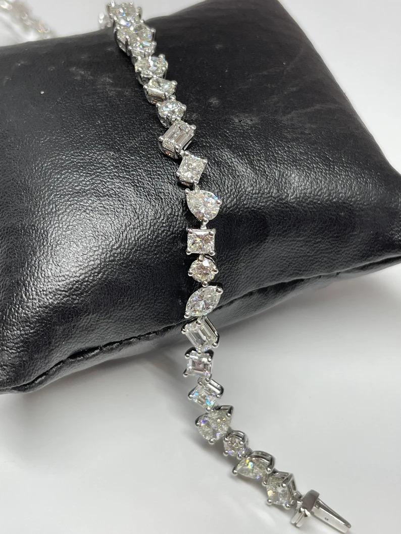 This gorgeous mix shape diamond bracelet features 40 diamonds weighing 5.61 cts set in platinum. The diamonds are graded E-F in color and VS1 in clarity. 