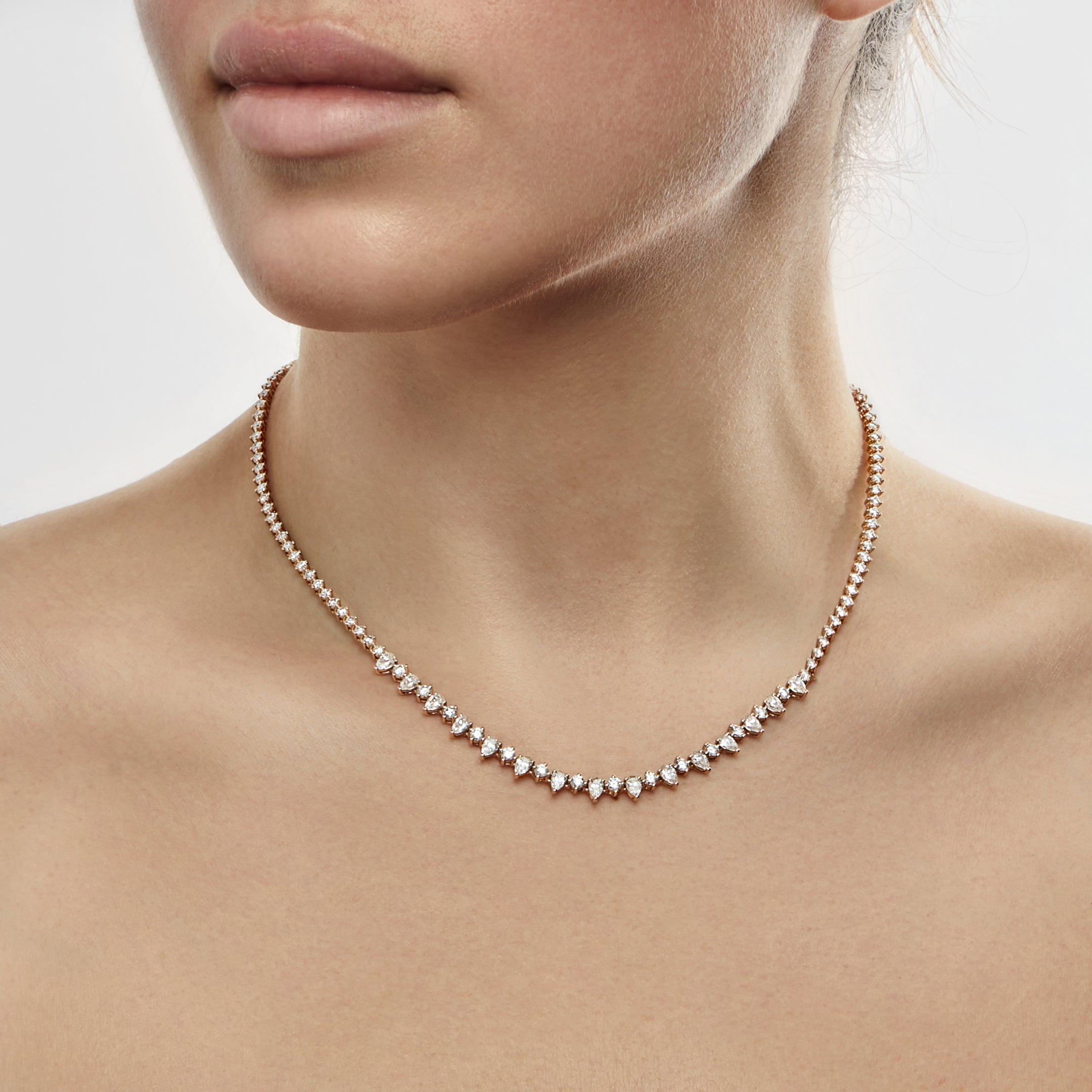 The Mixed Shape Diamond Tennis Necklace packs a punch, thanks to striking pear-shaped diamonds that are interspersed with round brilliant-cuts. The incredibly eye-catching style is the perfect fine jewelry base layer. It appears formal when worn