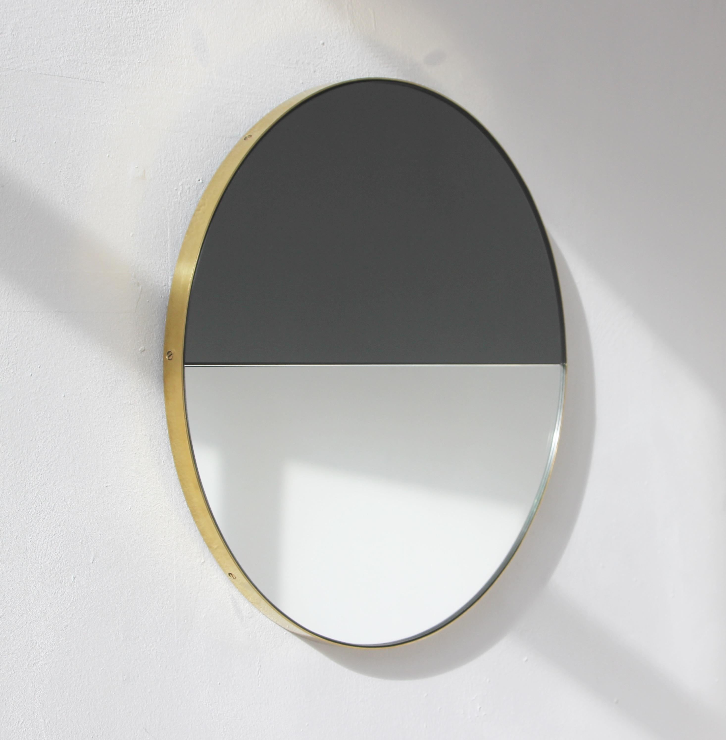 Contemporary handcrafted mixed tinted black and std. silver Orbis Dualis™ mirror with an elegant solid brushed brass frame. Fitted with a quality hanging system that allows a flexible installation in 6 different positions (see pictures for