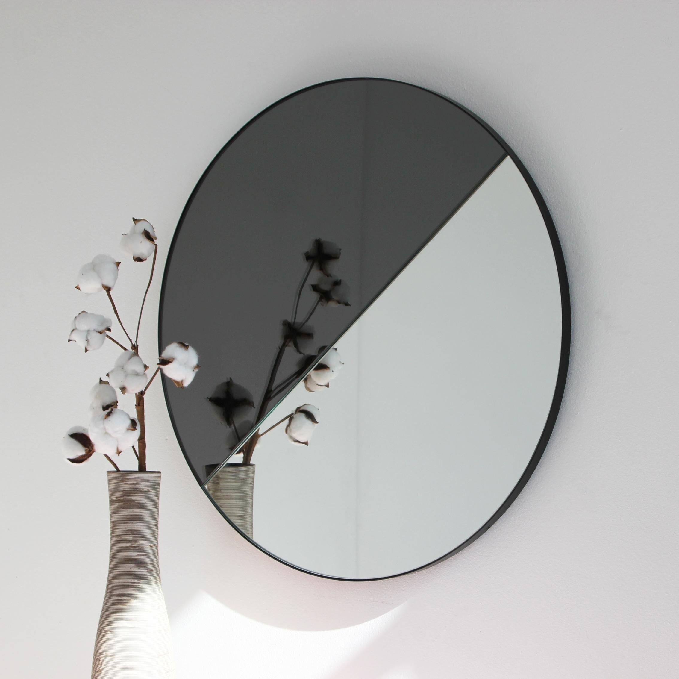 Contemporary mixed tinted (black & silver) round mirror with an elegant black frame. Designed and handcrafted in London, UK.

All mirrors are fitted with an ingenious French cleat (split batten) system so they may hang flush with the wall in four