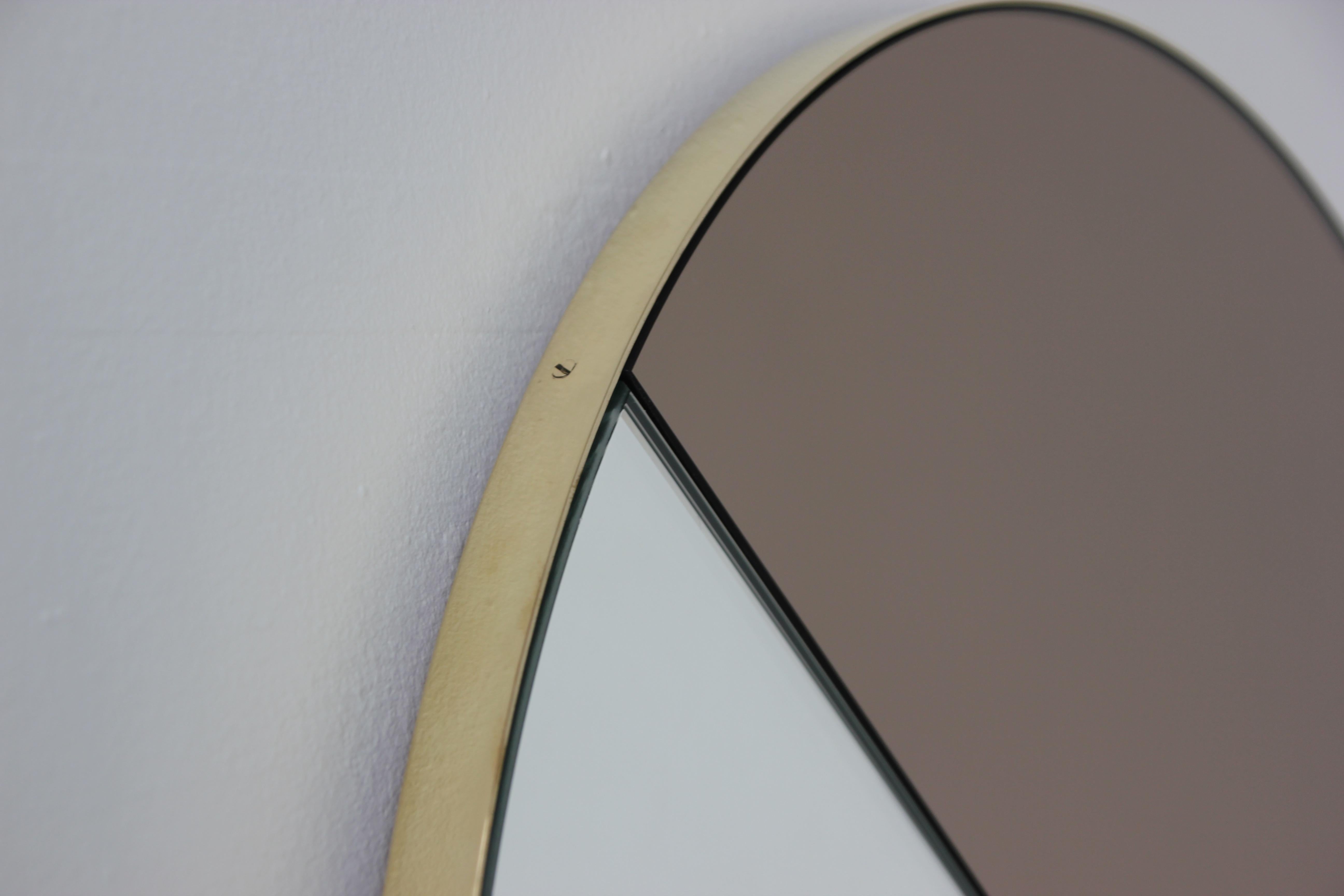 Contemporary mixed bronze and silver mirror tints Dualis Orbis with a brushed brass frame. Designed and handcrafted in London, UK.

All mirrors are fitted with an ingenious French cleat (split batten) system so they may hang flush with the wall in