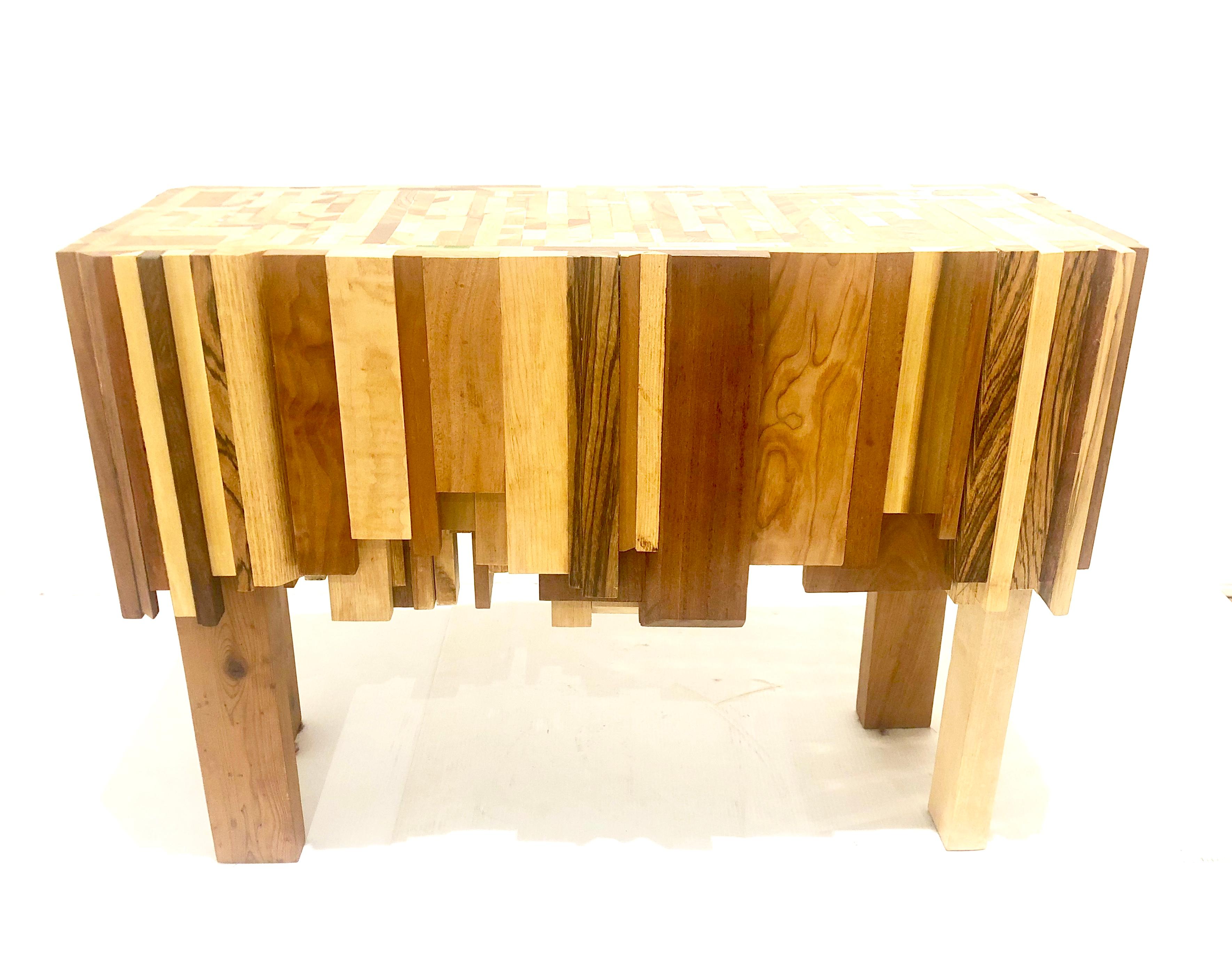 Artful table designed and built by artist Ben Darby. The table is made of multiple types of hard wood joined (solid core) to create a mosaic. Darby puts his artist stamp by integrating acrylic paint in various colors on the top surface. The bottom
