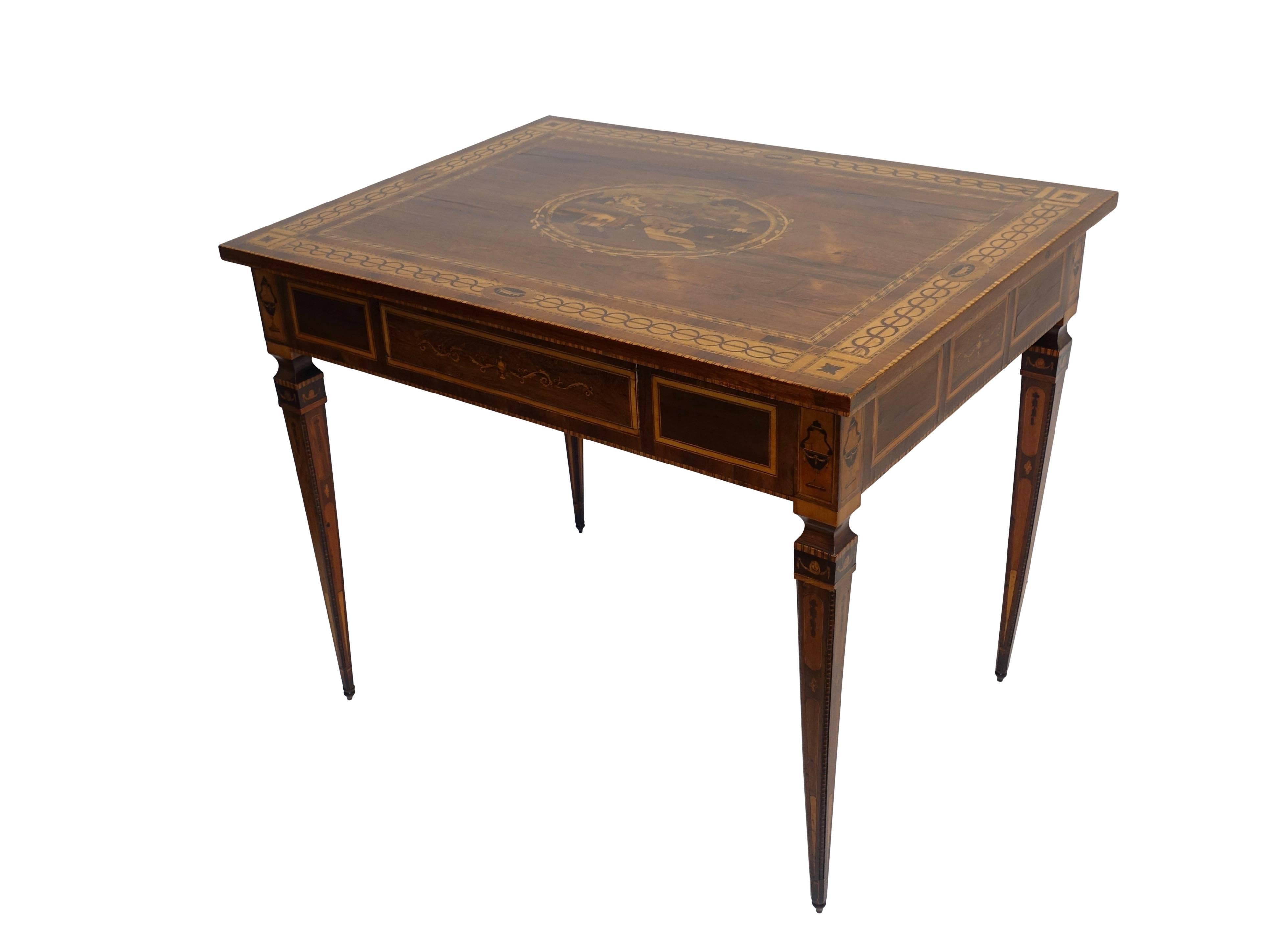 Fine Magilini style walnut and intricately inlaid fruitwood, walnut, black walnut, satinwood and rosewood center or writing table with one drawer on elegant tapering legs. Beautiful marquetry and parquetry work on all surfaces areas including the