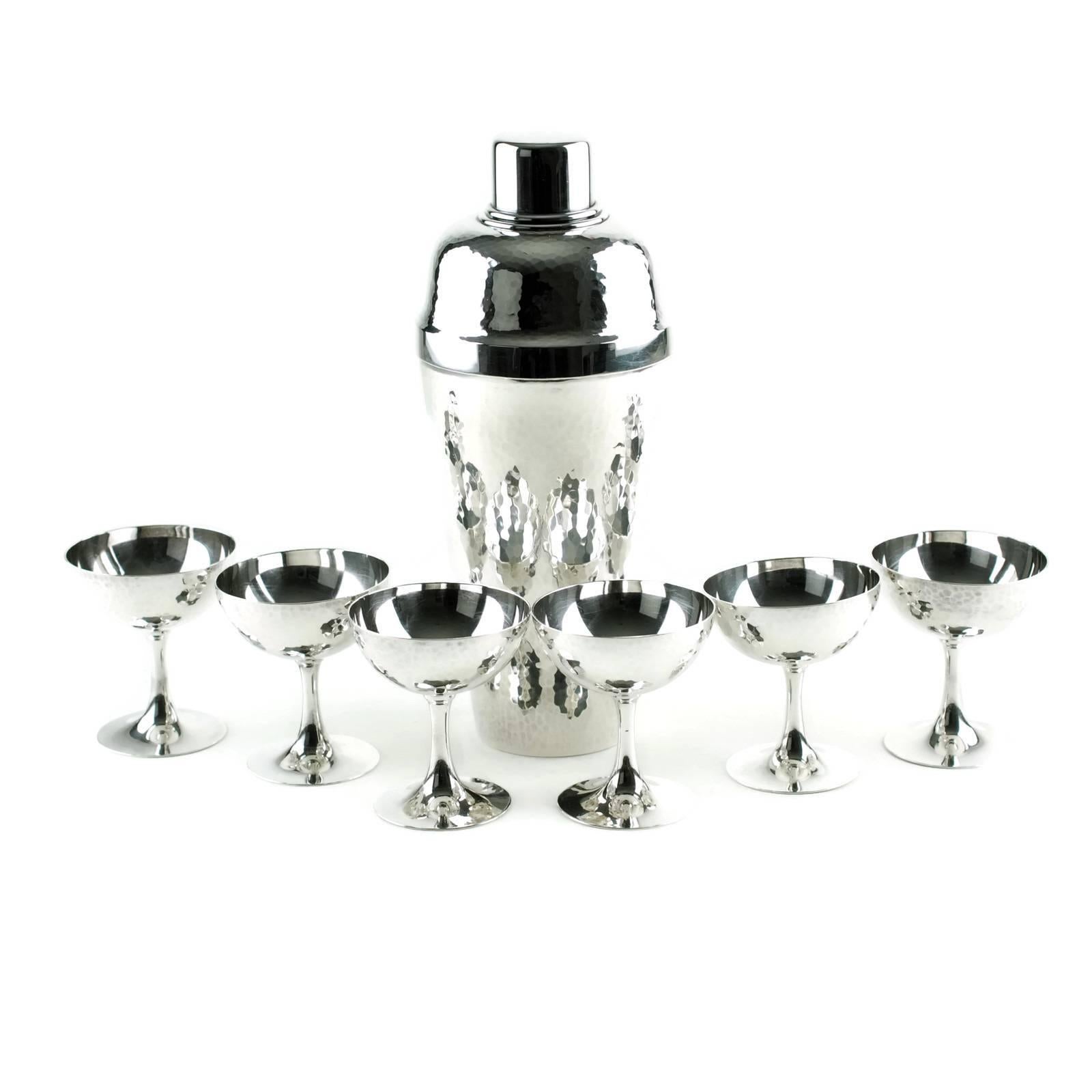 This hand-hammered sterling silver cocktail set was made by highly regarded Japanese silversmith Miyamoto Shoko Tokyo, established in 1880. Miyamoto holds a royal warrant from Japan's Imperial family and has designed and crafted pieces for the