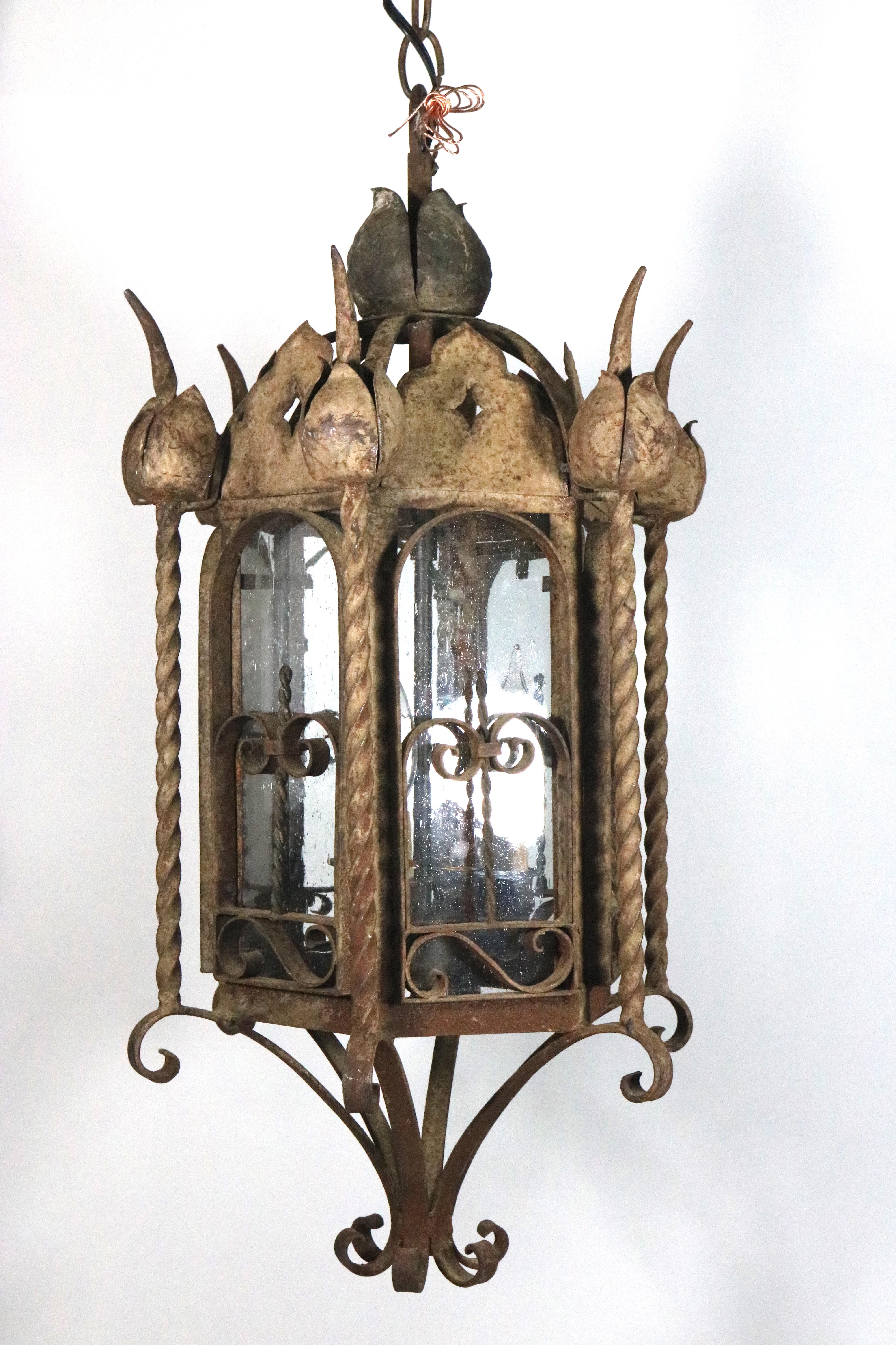 Gorgeous Mizner Palm Beach iron with rusticated finish exterior pair of garden lanterns/sconces. 
An impressive hanging lantern with a chain and canopy
or wall-mounted lantern sconces (we have the wall mount arms) for your Mansion.
3-light interior