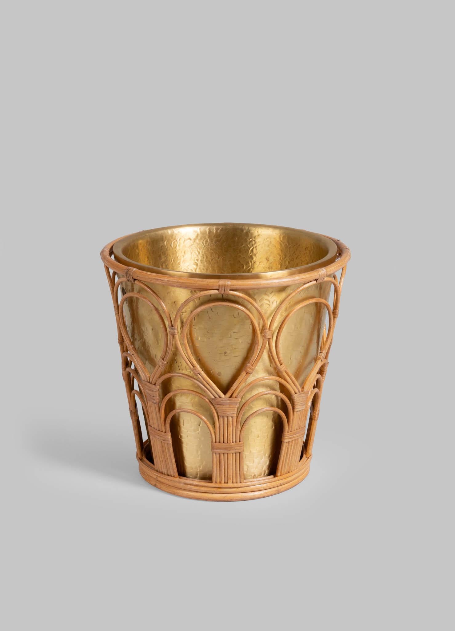 Mizoram Champagne Bucket in Brass and Cane, Viya By Vikram Goyal

A classic pairing, reimagined. Robust cane becomes latticed second skin to the hand-beaten brass objects in an effortless collaboration. These barware accessories are crafted as