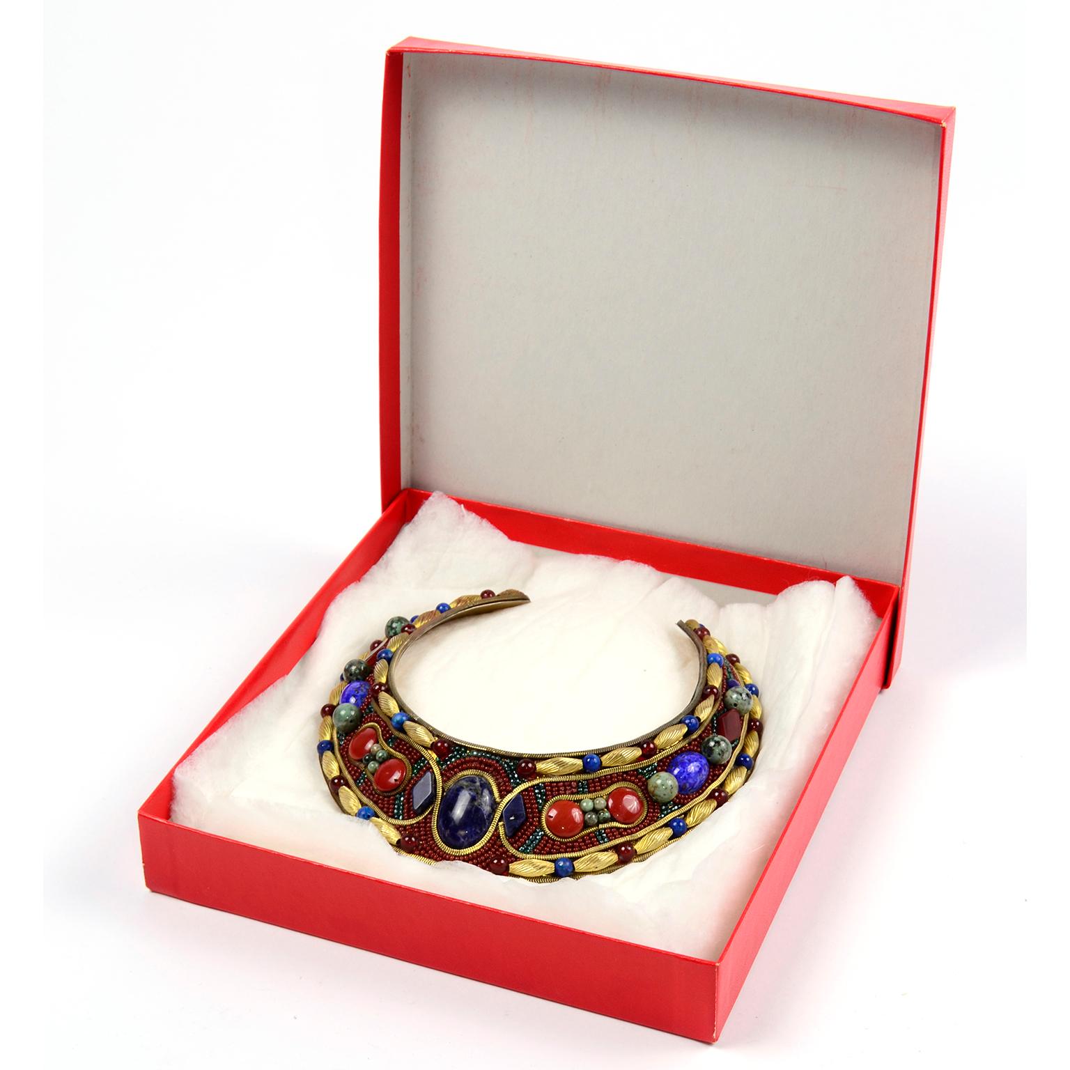 This unique, Egyptian style colorful vintage necklace was designed by MJ Hansen in 1988. This incredible brass choker collar necklace is covered with gold metalwork, beads and gorgeous gemstone cabochons, including a large center Lapis Lazuli. This