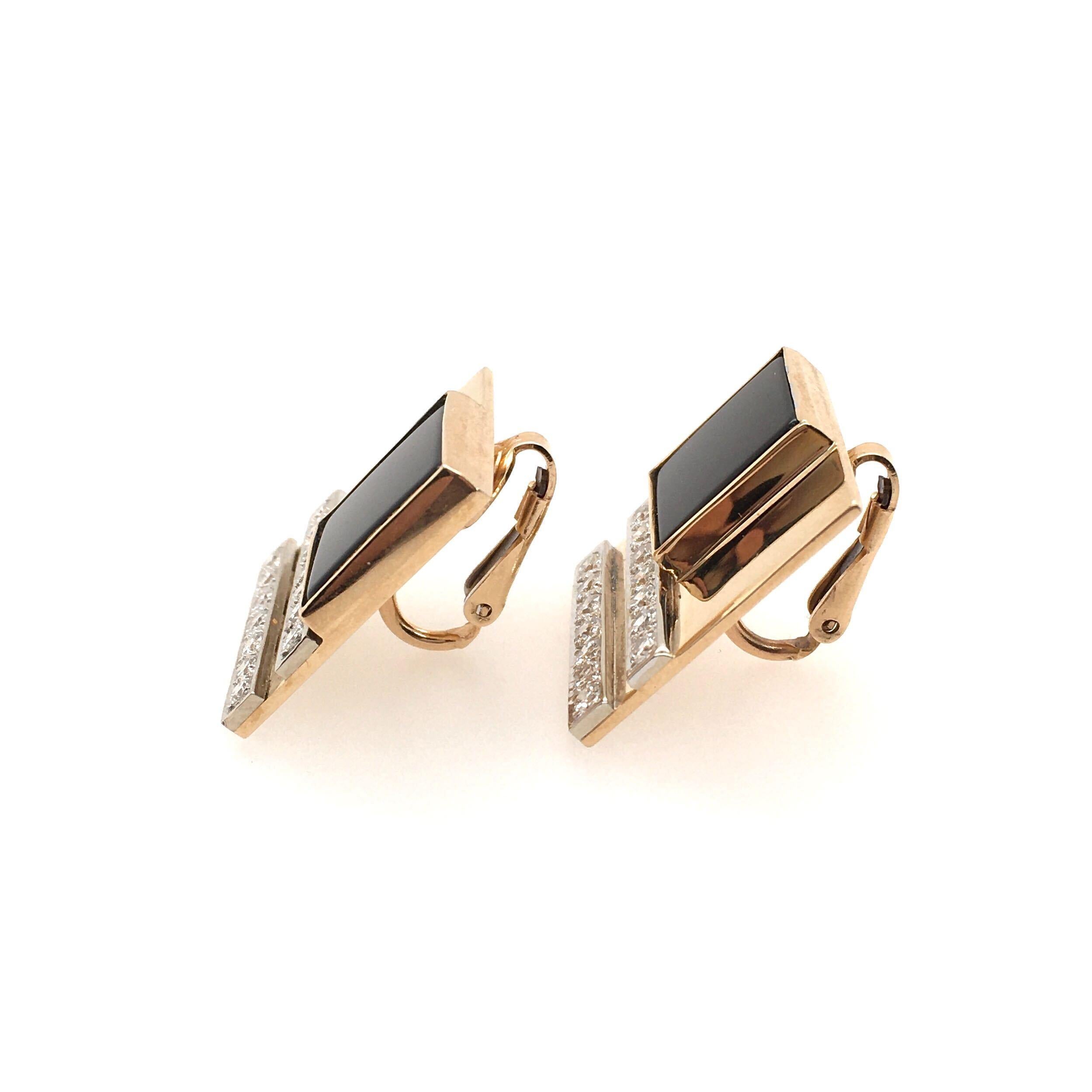 A pair of yellow gold black onyx and diamond earrings. M.J. Savitt. Of square geometric design, set with black onyx and pave diamond lines. Length is approximately 7/8 inches, gross weight is approximately 17.0 grams