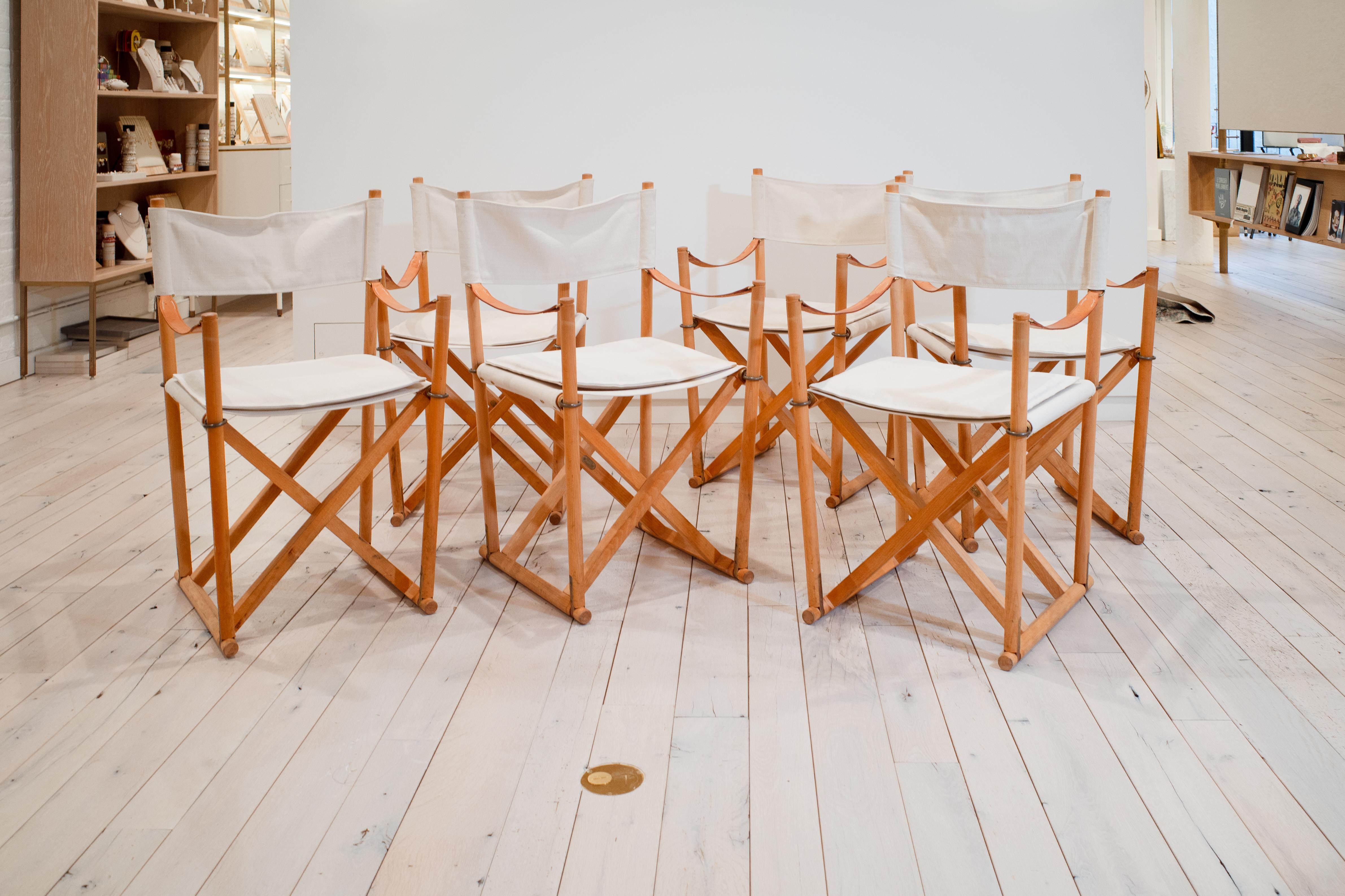 This complete set of six MK-16 Folding Safari Chairs is an iconic representation of Danish functionalist design. Conceived in 1932 by the celebrated architect Mogens Koch, the design was revolutionary for its time, drawing on the utilitarian