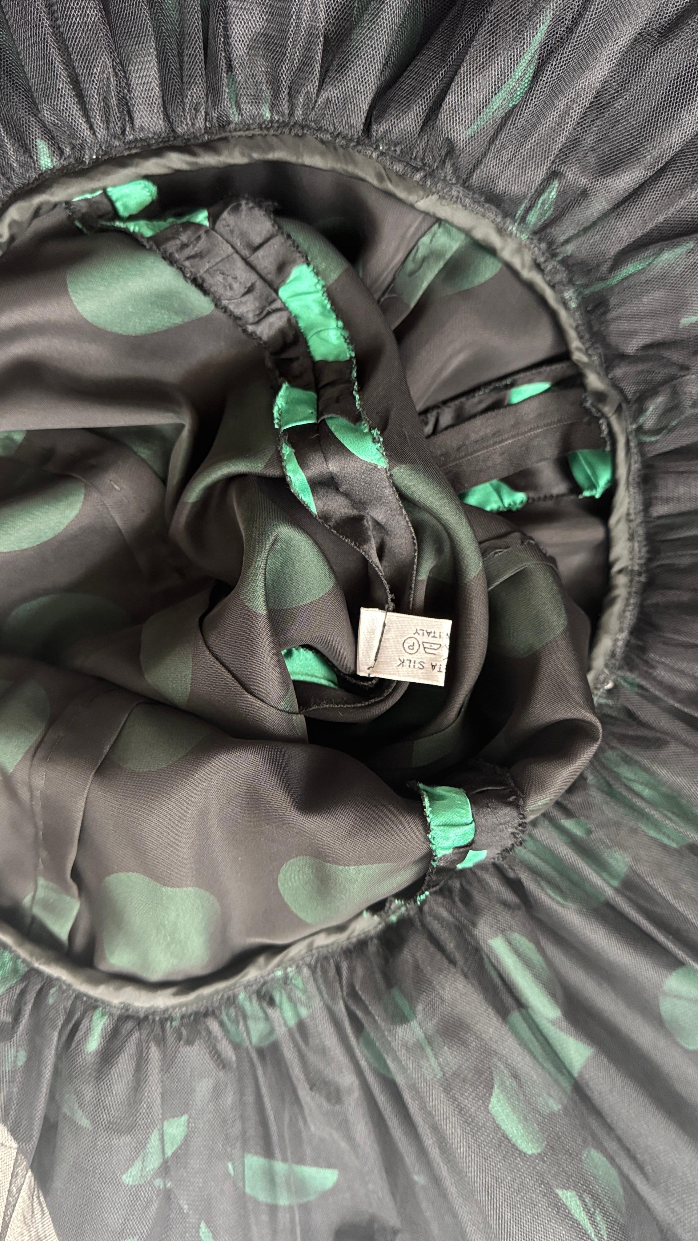 Step into the bold glamour of the 1980s with this eye-catching silk dress by ML Couture, made in Italy. Crafted from a luxurious black silk satin with oversized emerald green polka dots, this piece channels a vibrant, playful spirit while