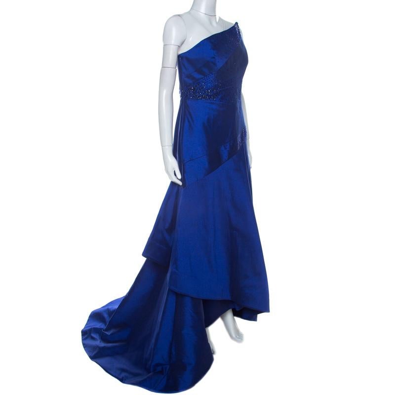 This blue Monique Lhuillier dress is a show-stopper! It is exquisitely crafted out of quality fabrics and adorned with beads to accentuate the draped front and craftsmanship. The strapless gown is beautifully cut to give the illusion of a